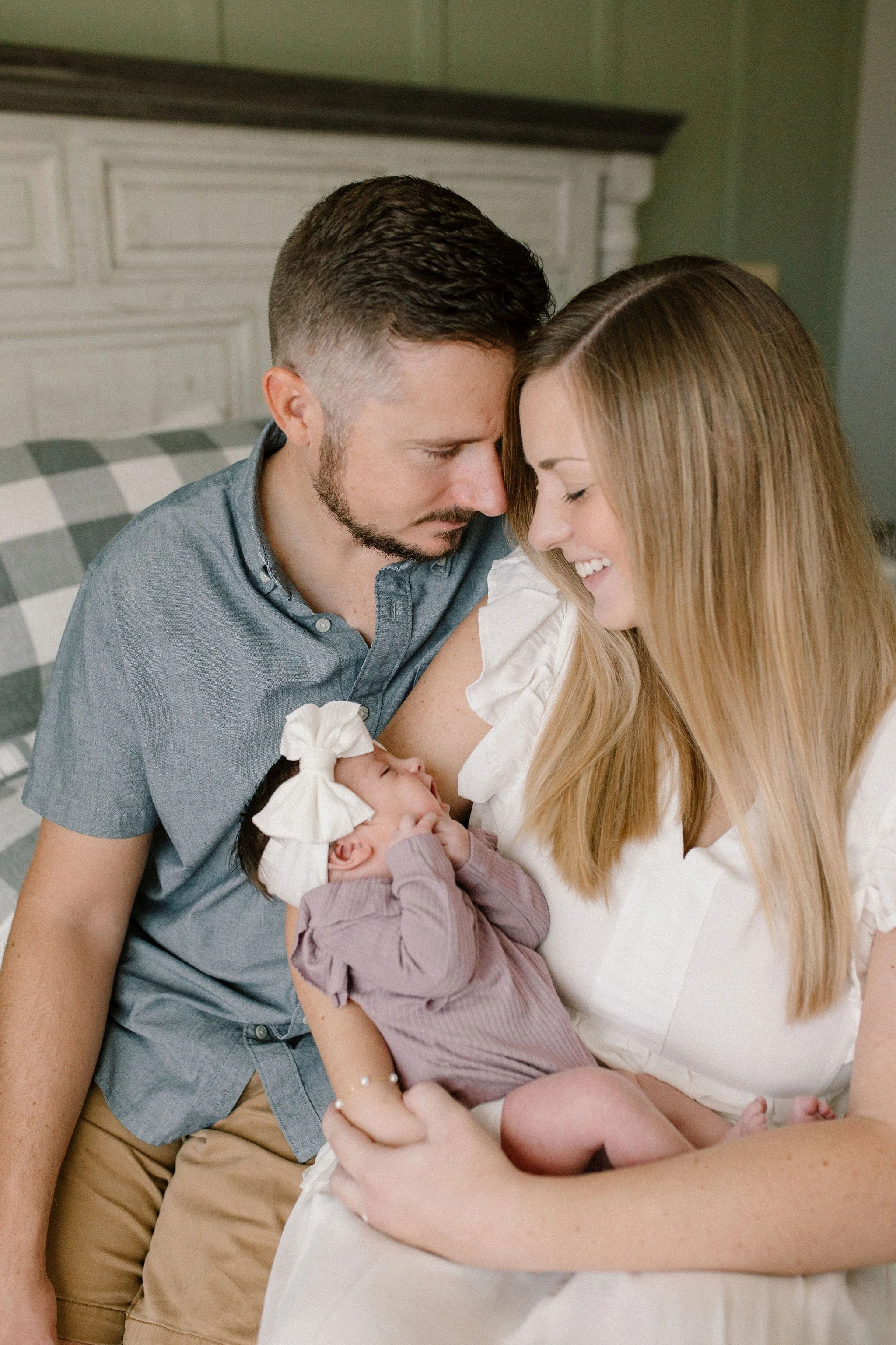 Mom and dad holding baby captured by Mesa newborn photographer