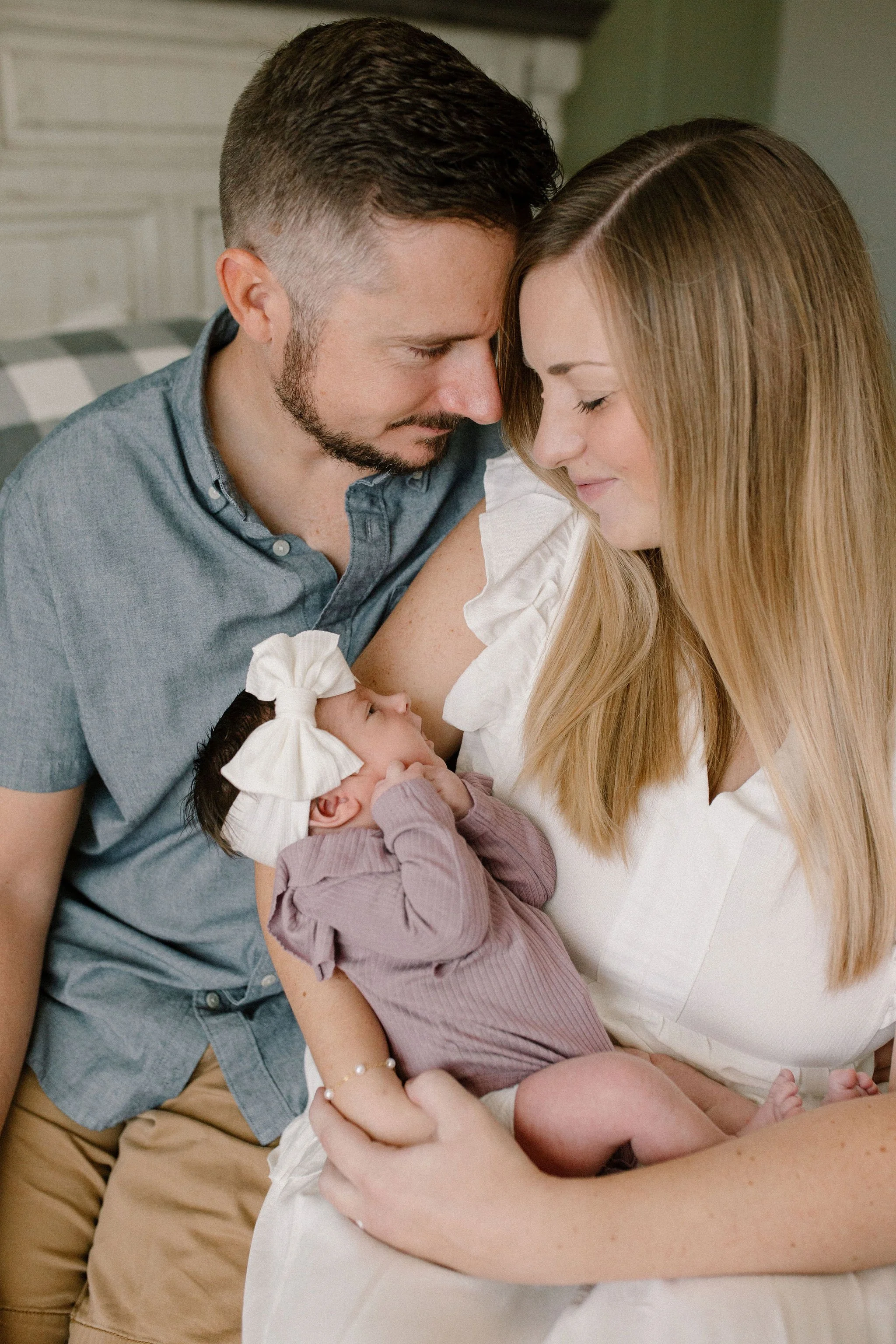 mom and dad holding baby captured by Mesa newborn photographer
