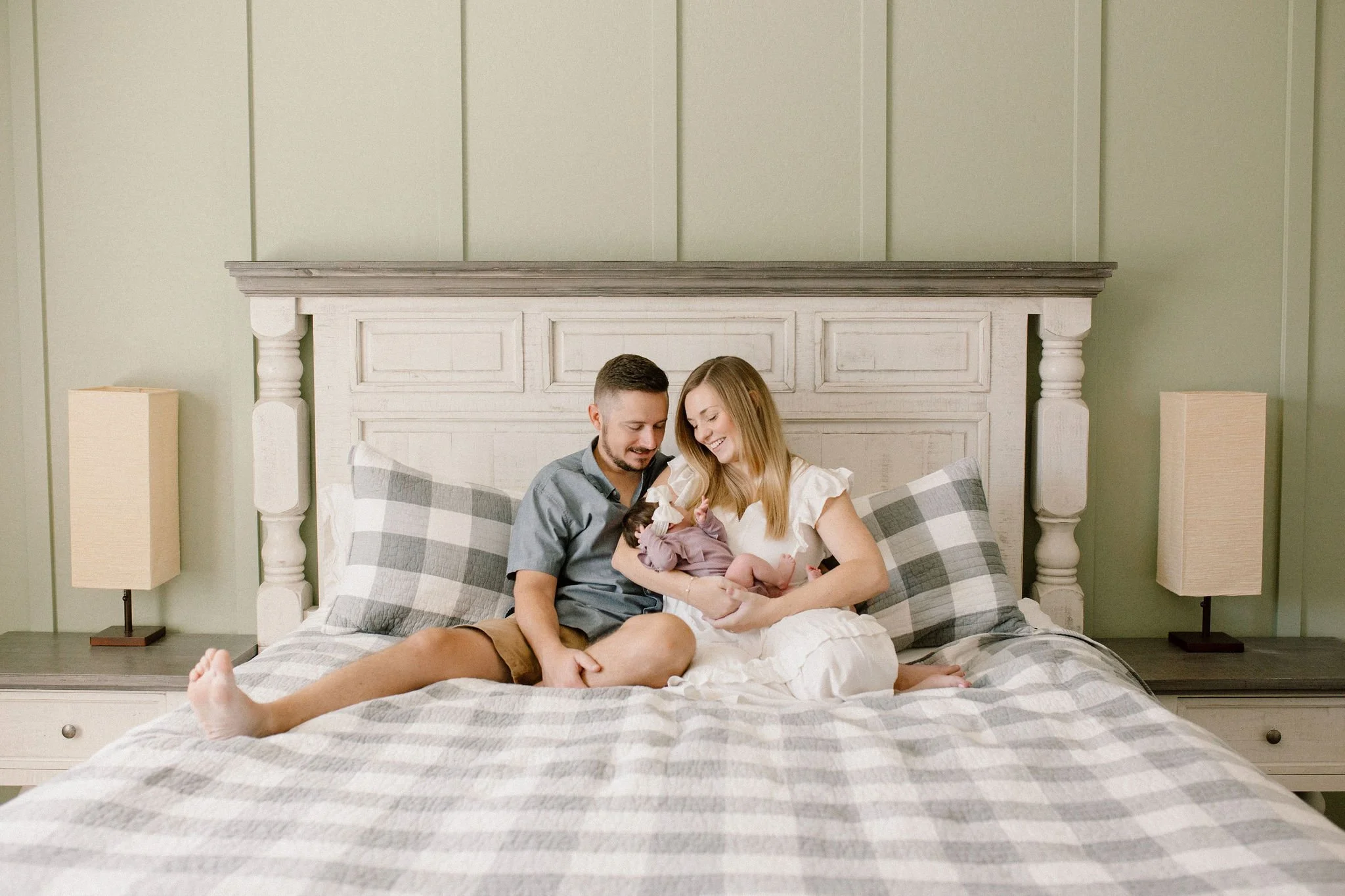 mom and dad holding baby in bed by Mesa newborn photographer