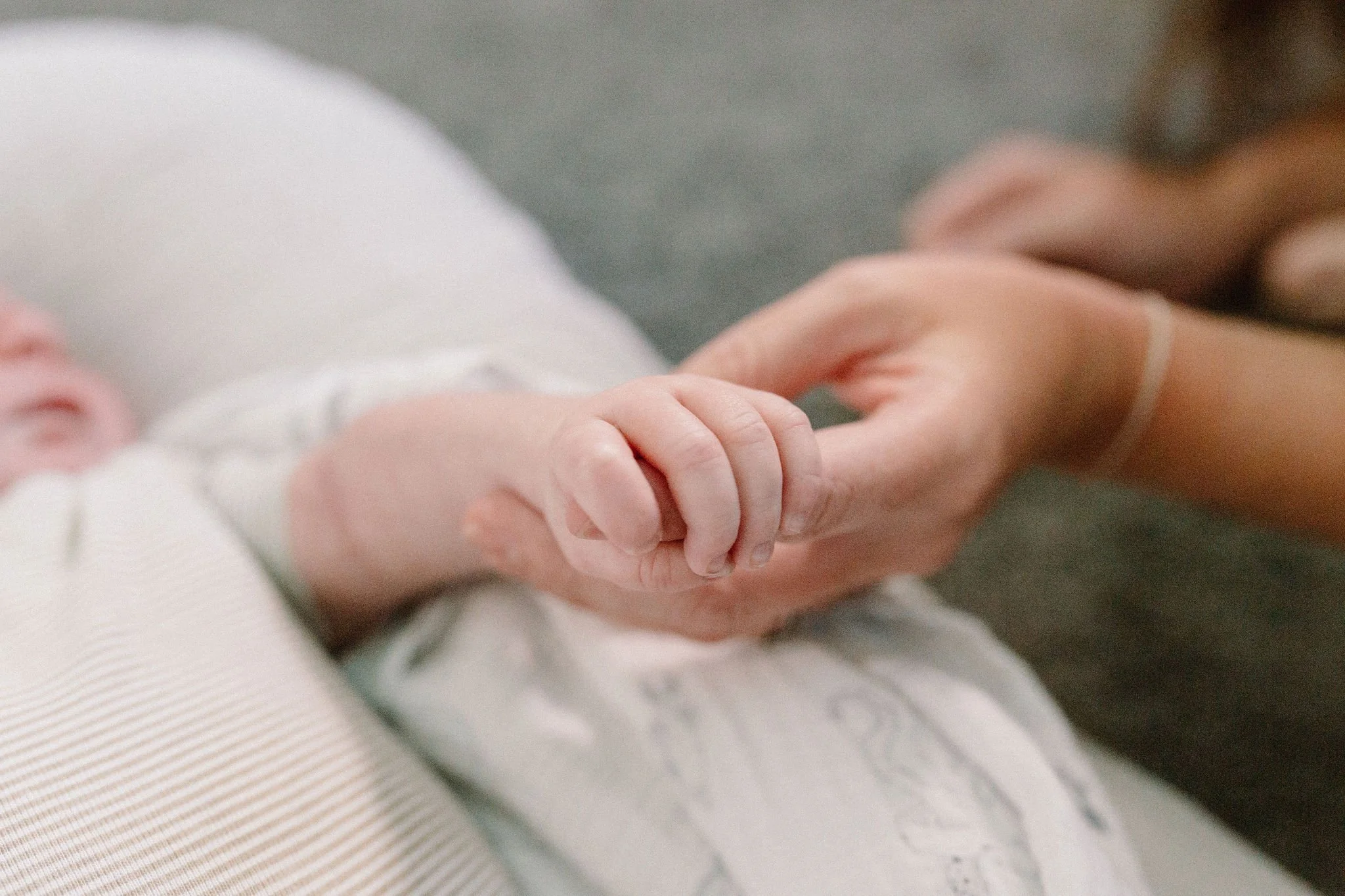 baby holding mom's finger close-up detail shot of baby's hand captured by Tempe Arizona newborn photographer