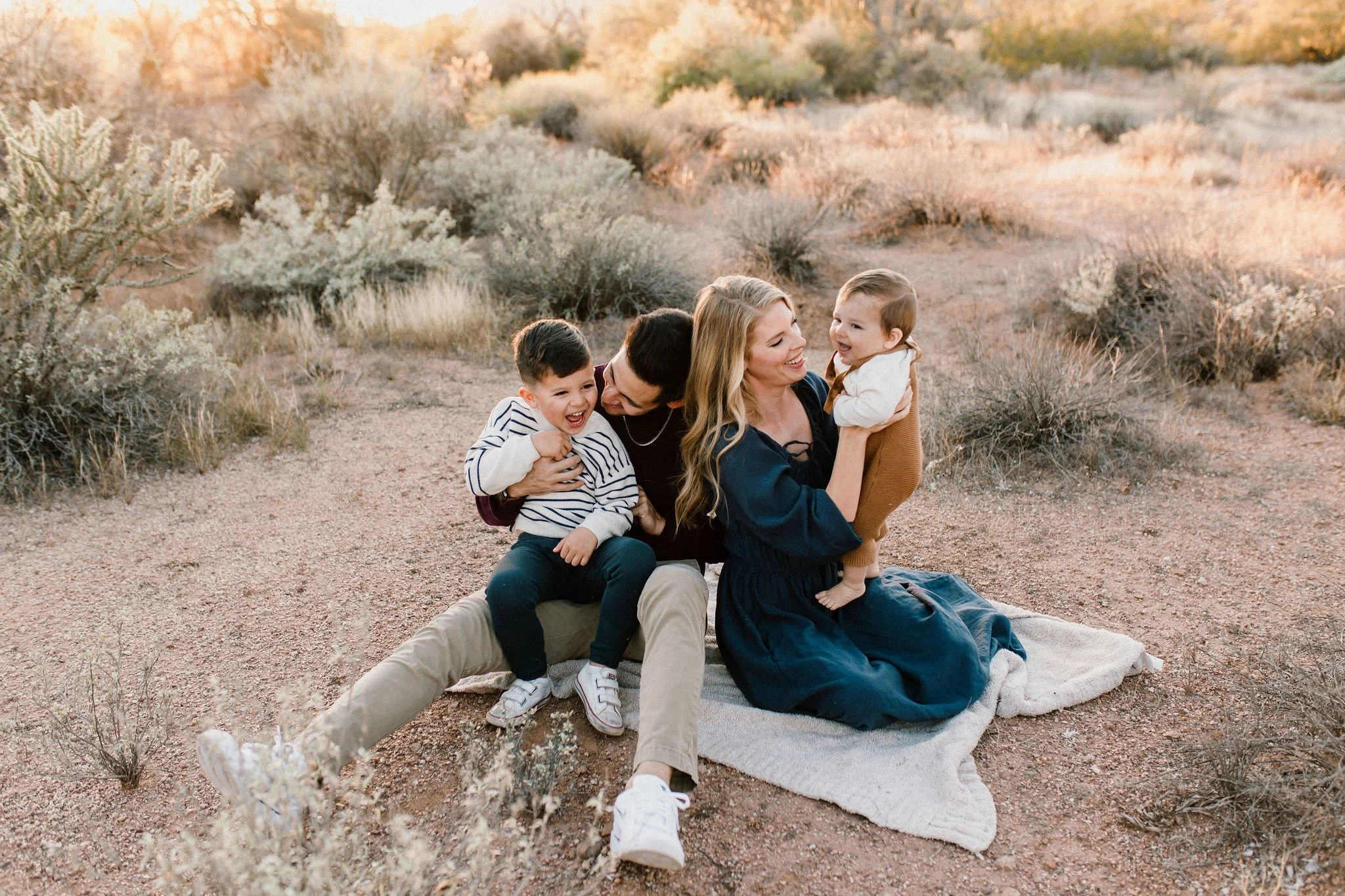 family sitting together in desert golden hour photography session in Gilbert, Arizona