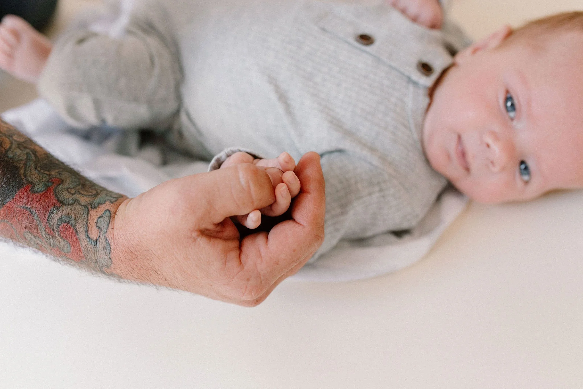 dad holding baby hand close-up detail shot by Phoenix newborn photographer