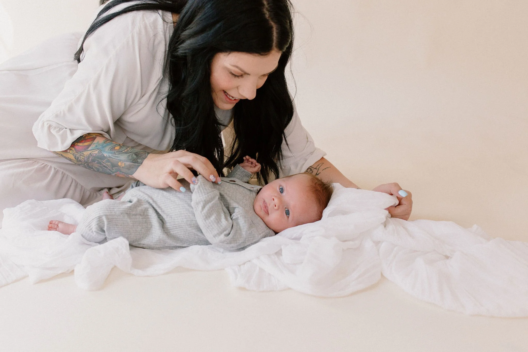 mom playing with baby in natural light studio by Phoenix newborn photographer