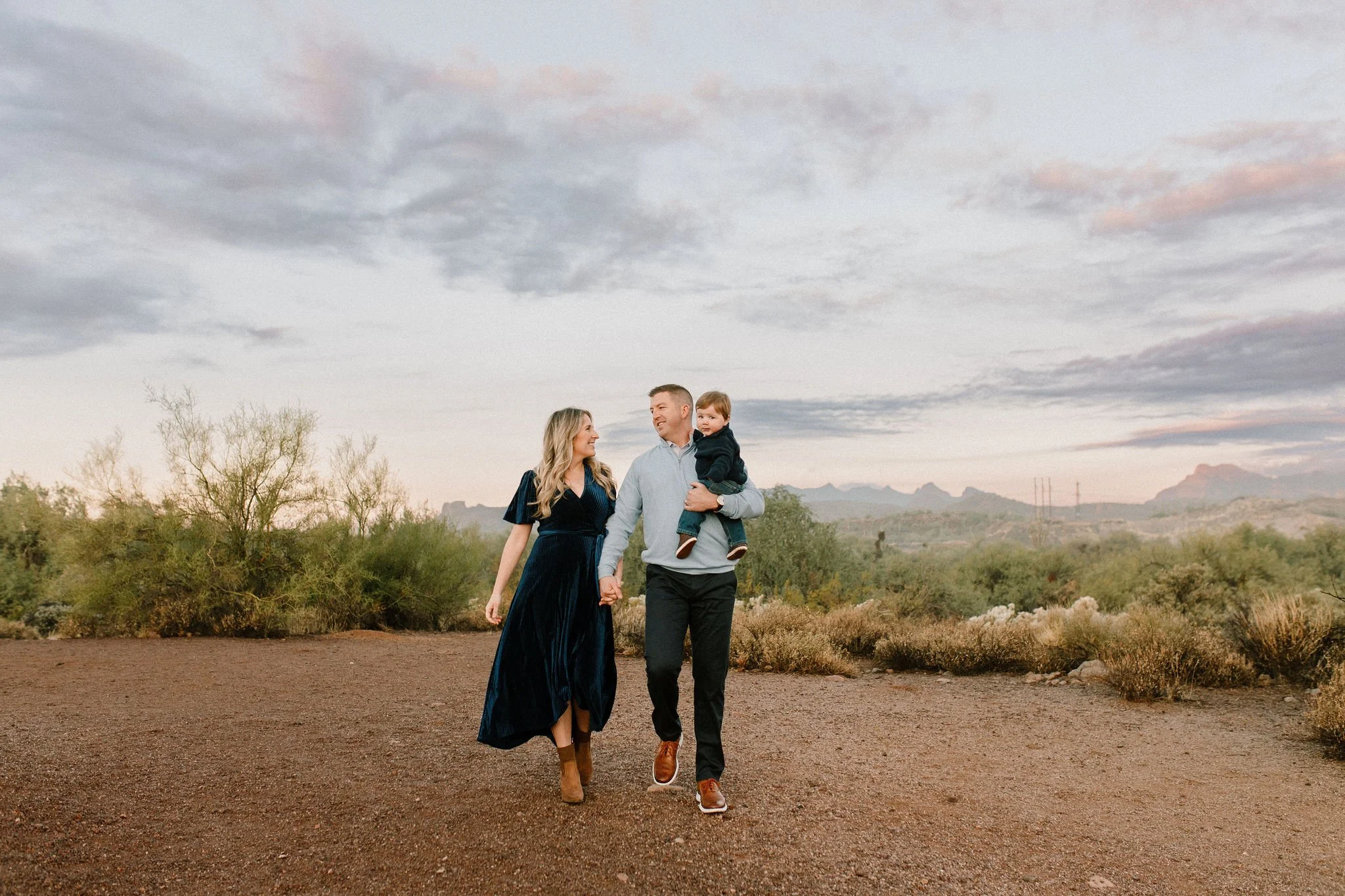 family of three walking in the desert during blue hour
