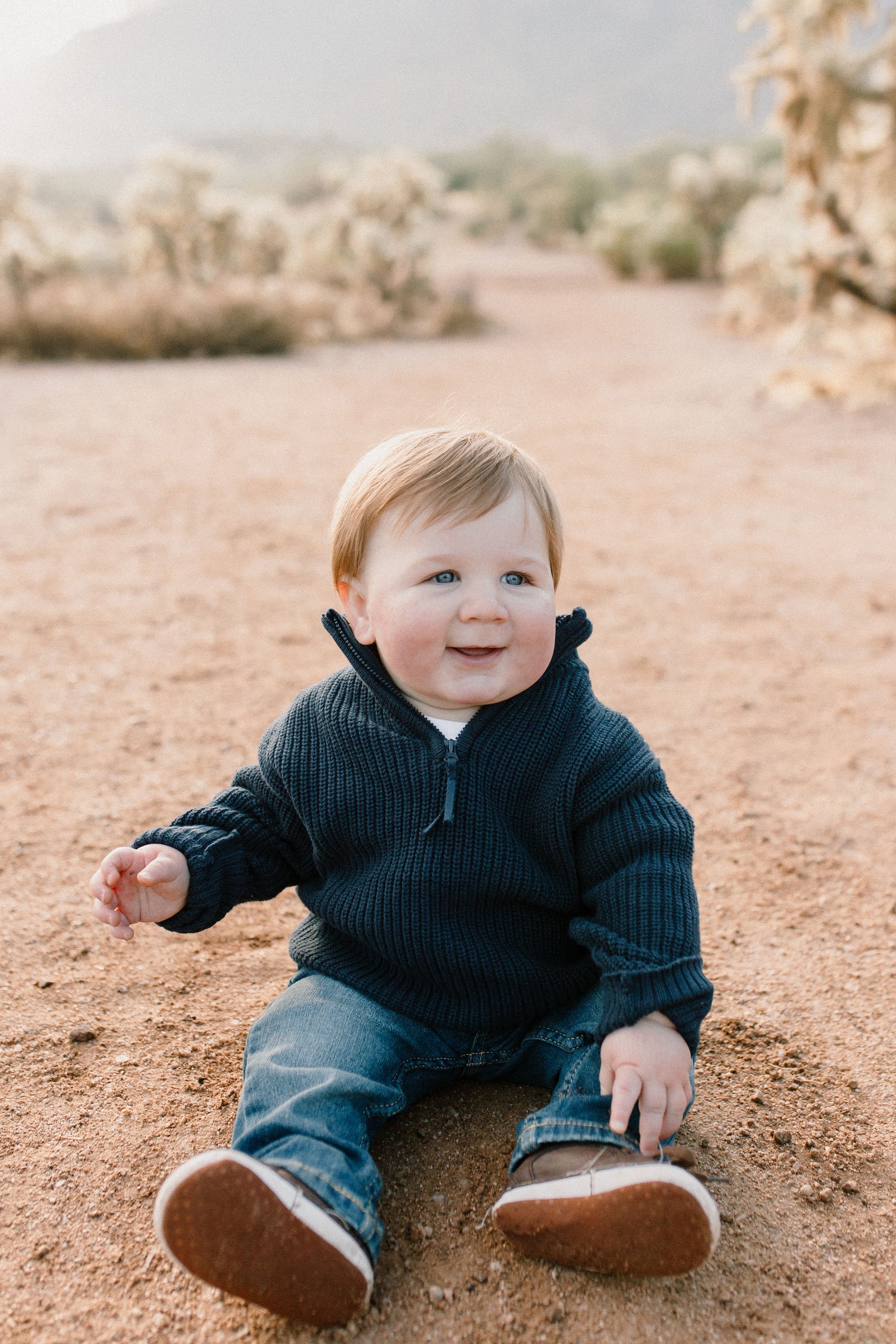 baby boy sitting in desert at misty morning photography session at the Superstition Mountains in Arizona