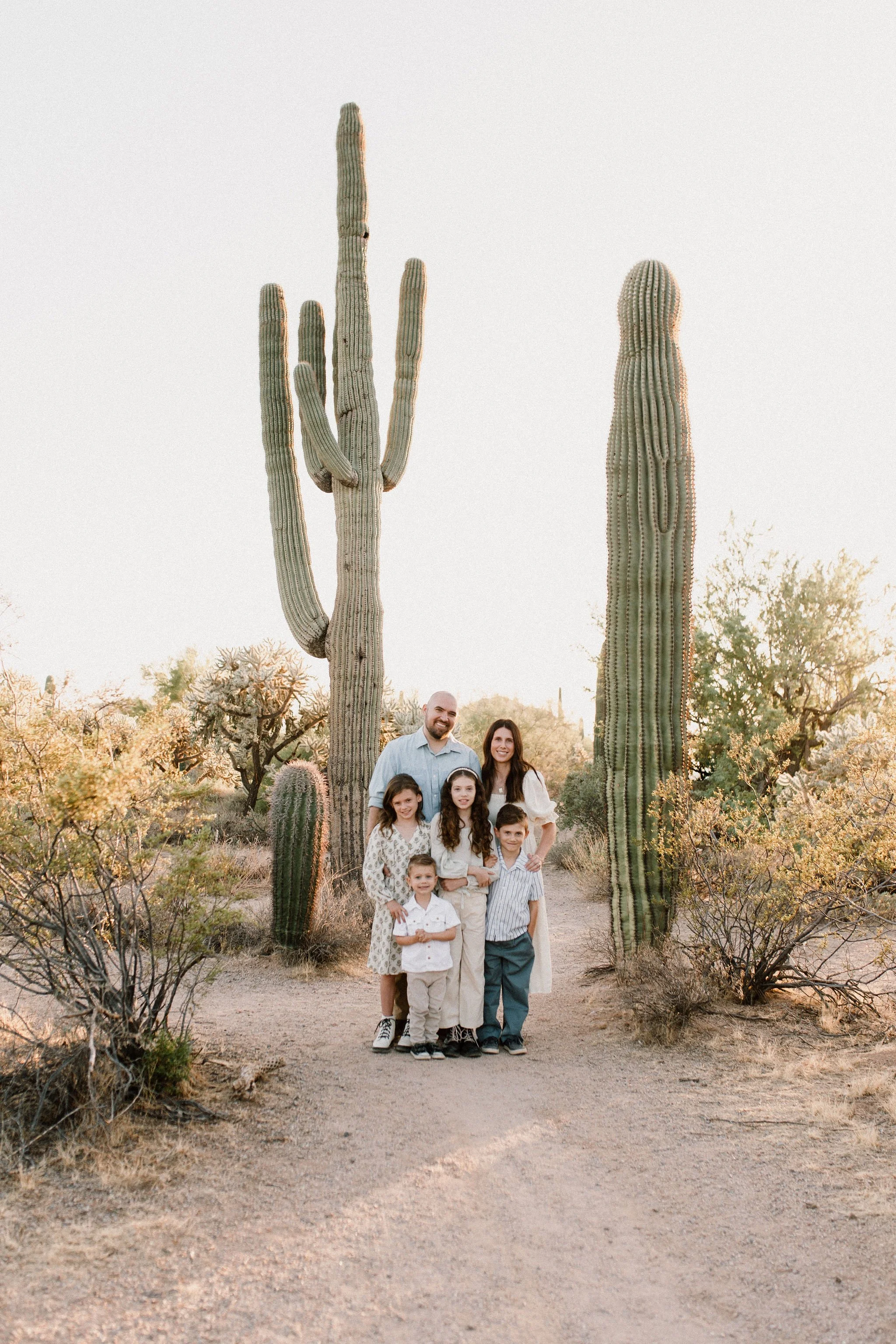 Family smiling at mesa family photographer in the Arizona desert