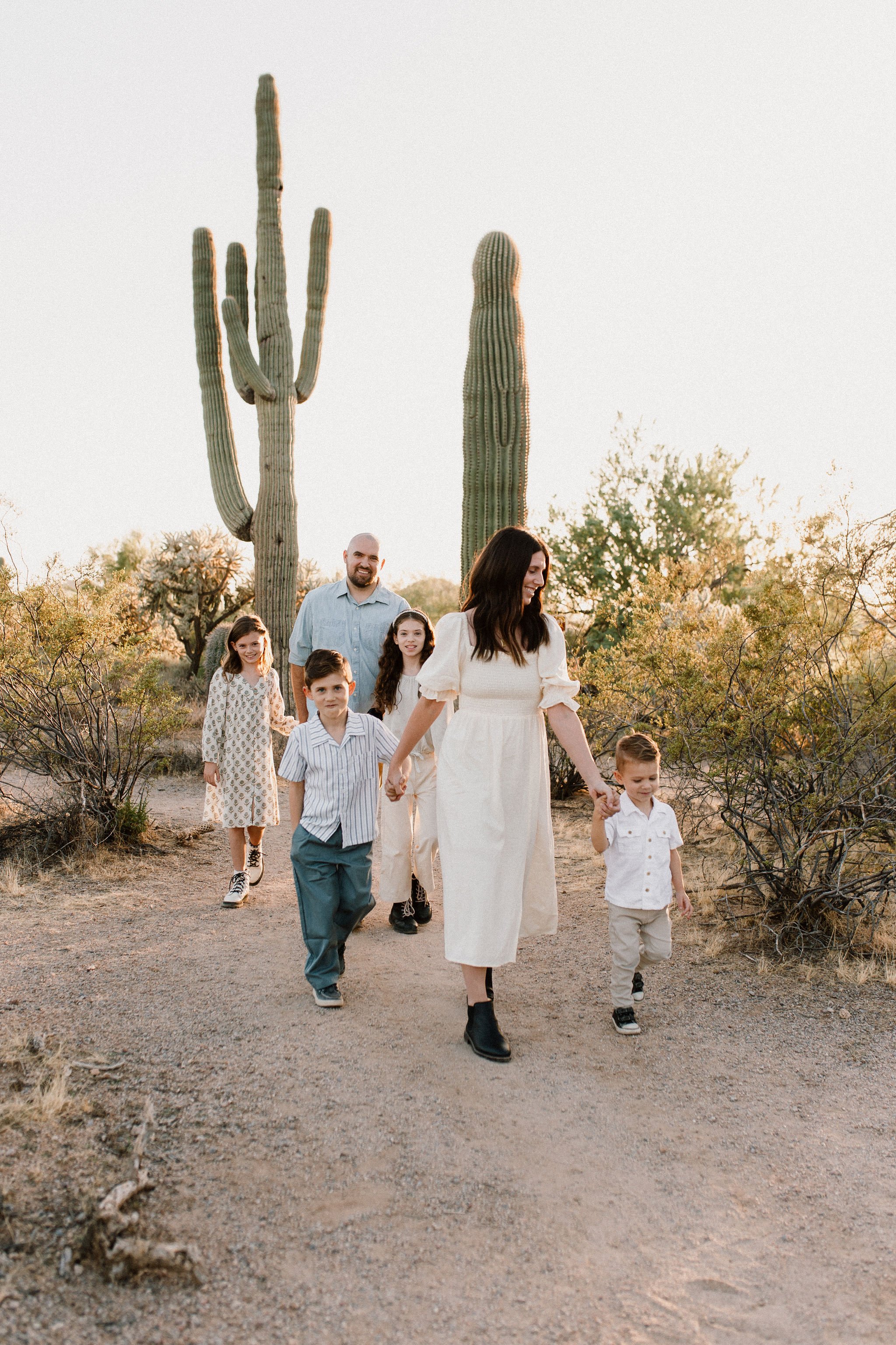 family walking captured by Mesa family photographer in the Arizona desert