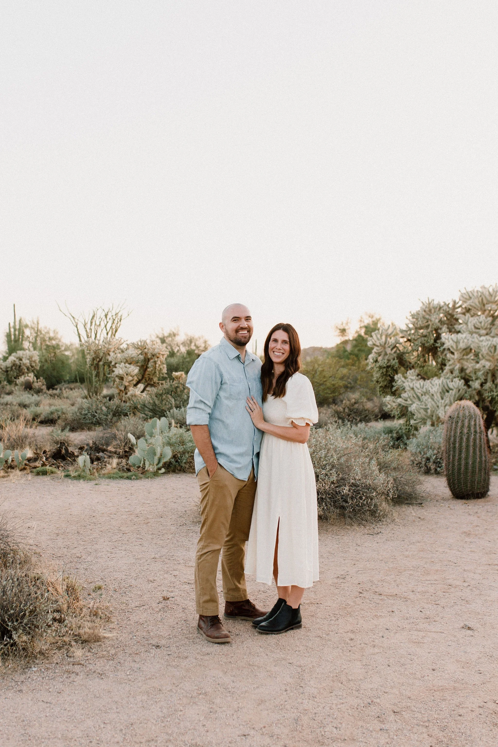 Mom and dad smiling at Mesa family photographer in Arizona desert