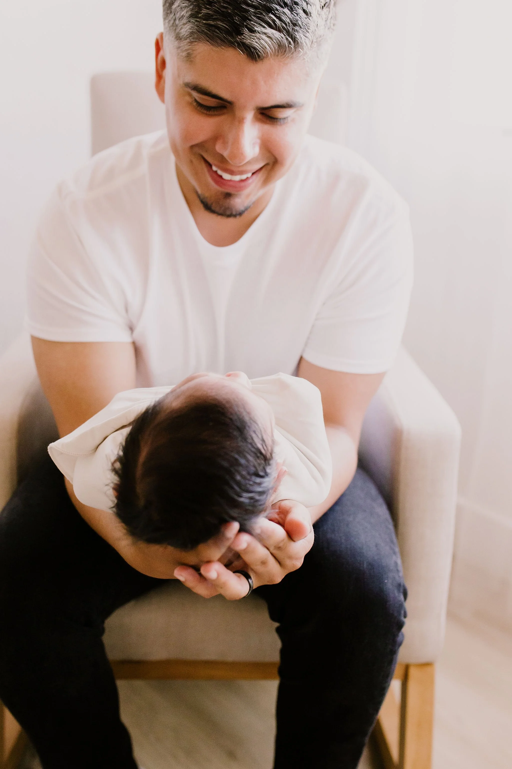 dad holding baby in studio newborn photography session