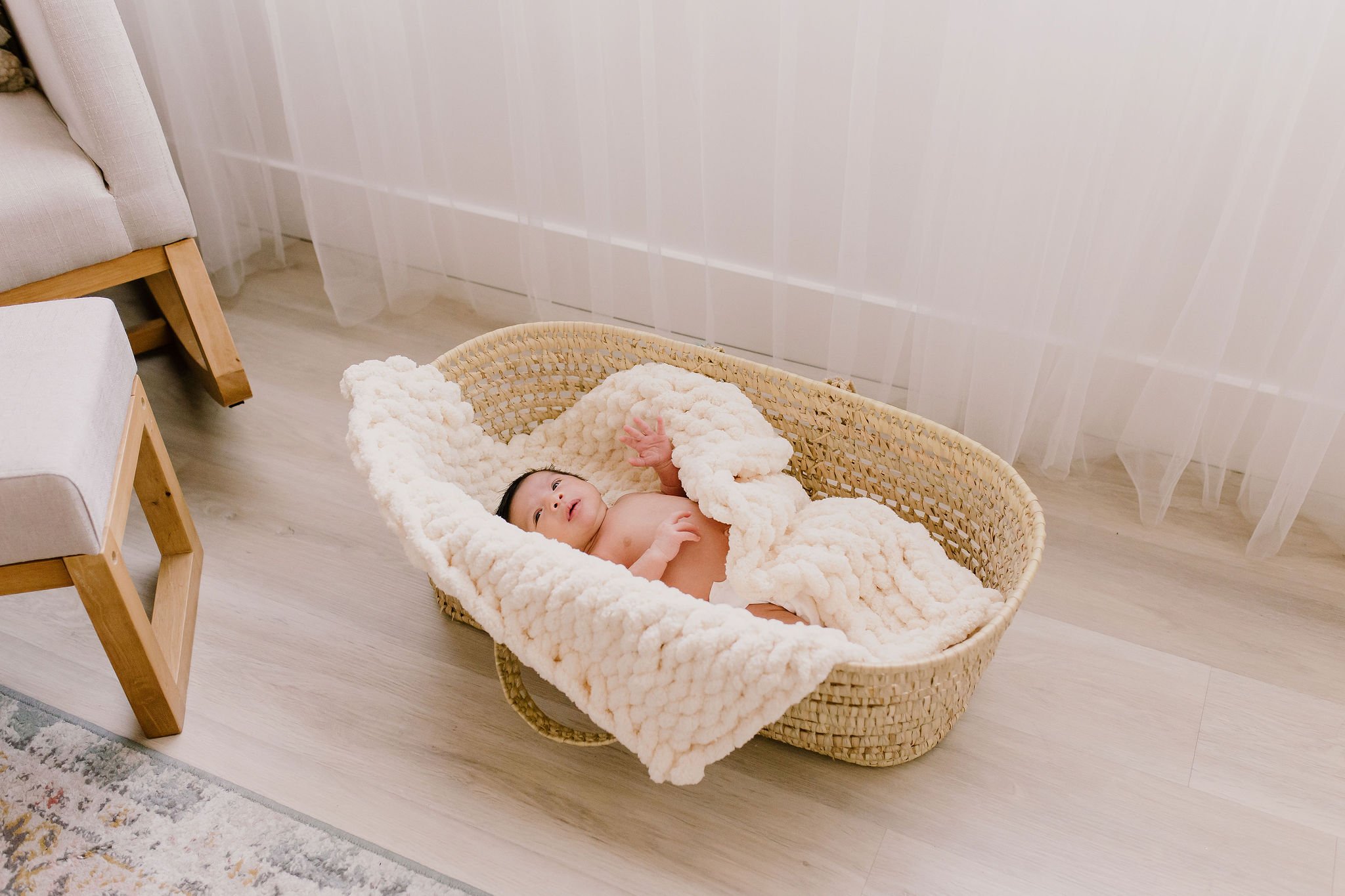 baby laying in Moses basket in Beloved Studios during studio newborn photography session