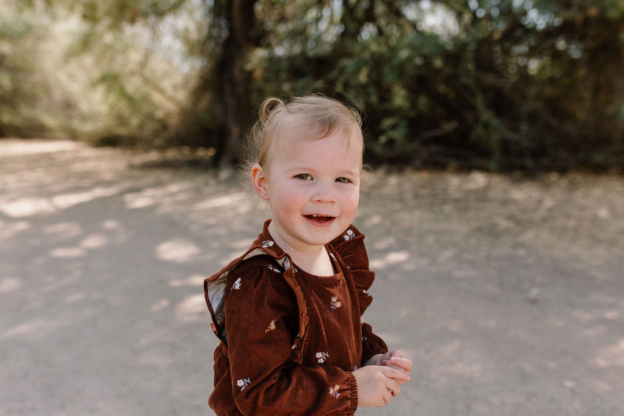 toddler girl smiling at Gilbert Arizona family photographer
