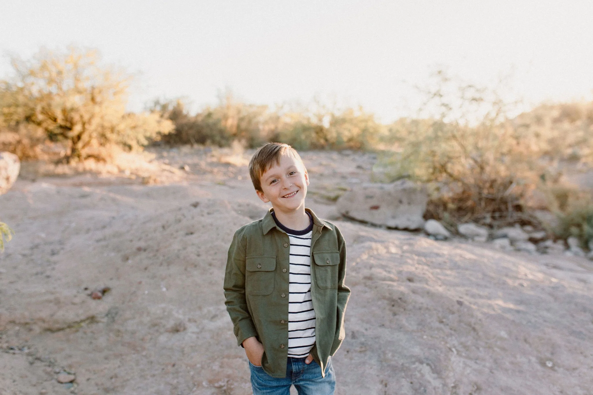 son smiling in desert family photography session at the salt river
