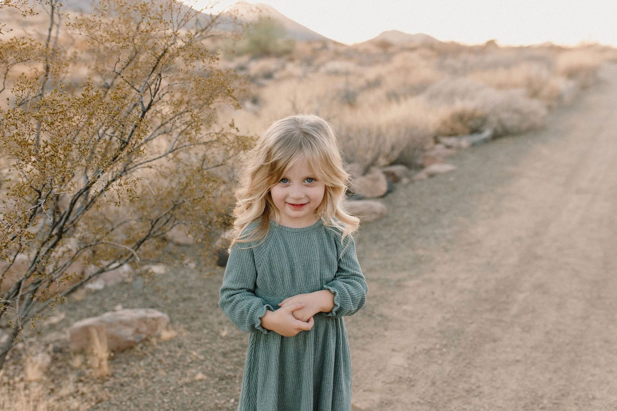 toddler standing in the desert smiling at Phoenix Arizona maternity photographer