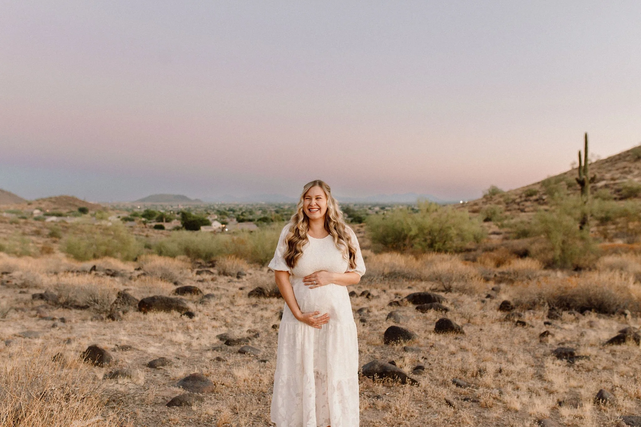 pregnant mom holding belly during blue hour maternity photoshoot in Gilbert, Arizona