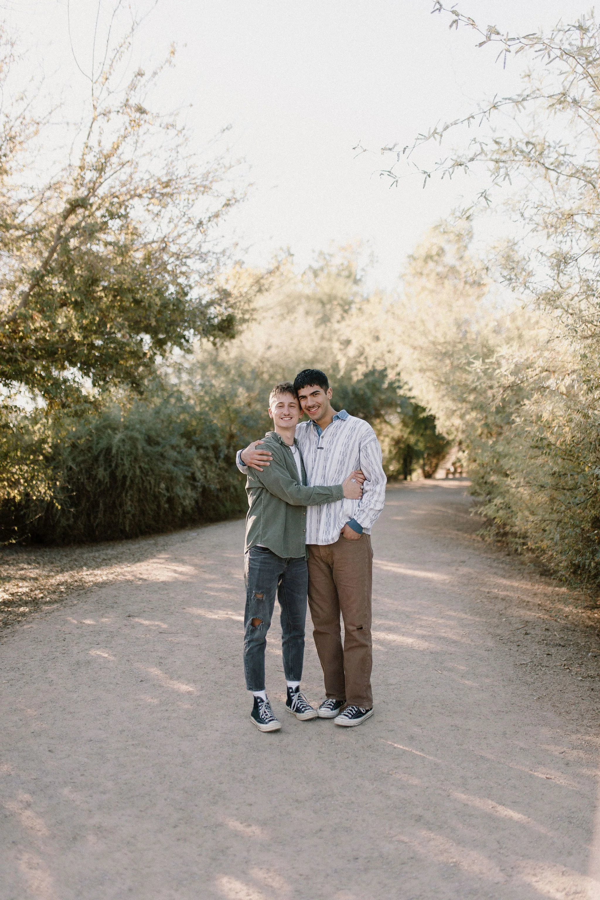 couple standing together smiling in desert greenery extended family photography session