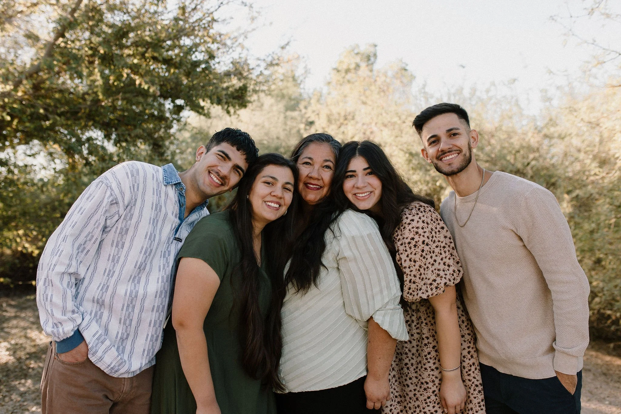 mom smiling with adult children during extended family photography session