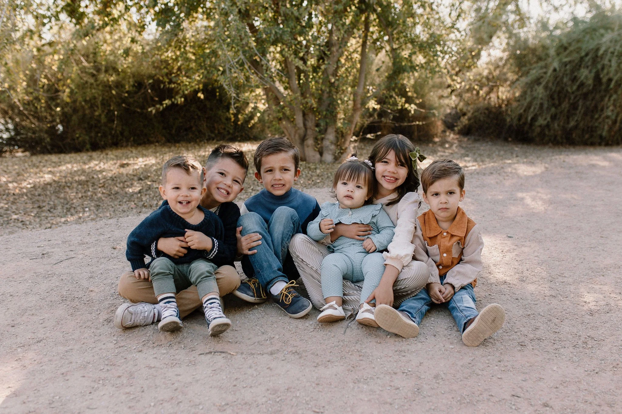 cousins sitting together and smiling during gilbert extended family photo session