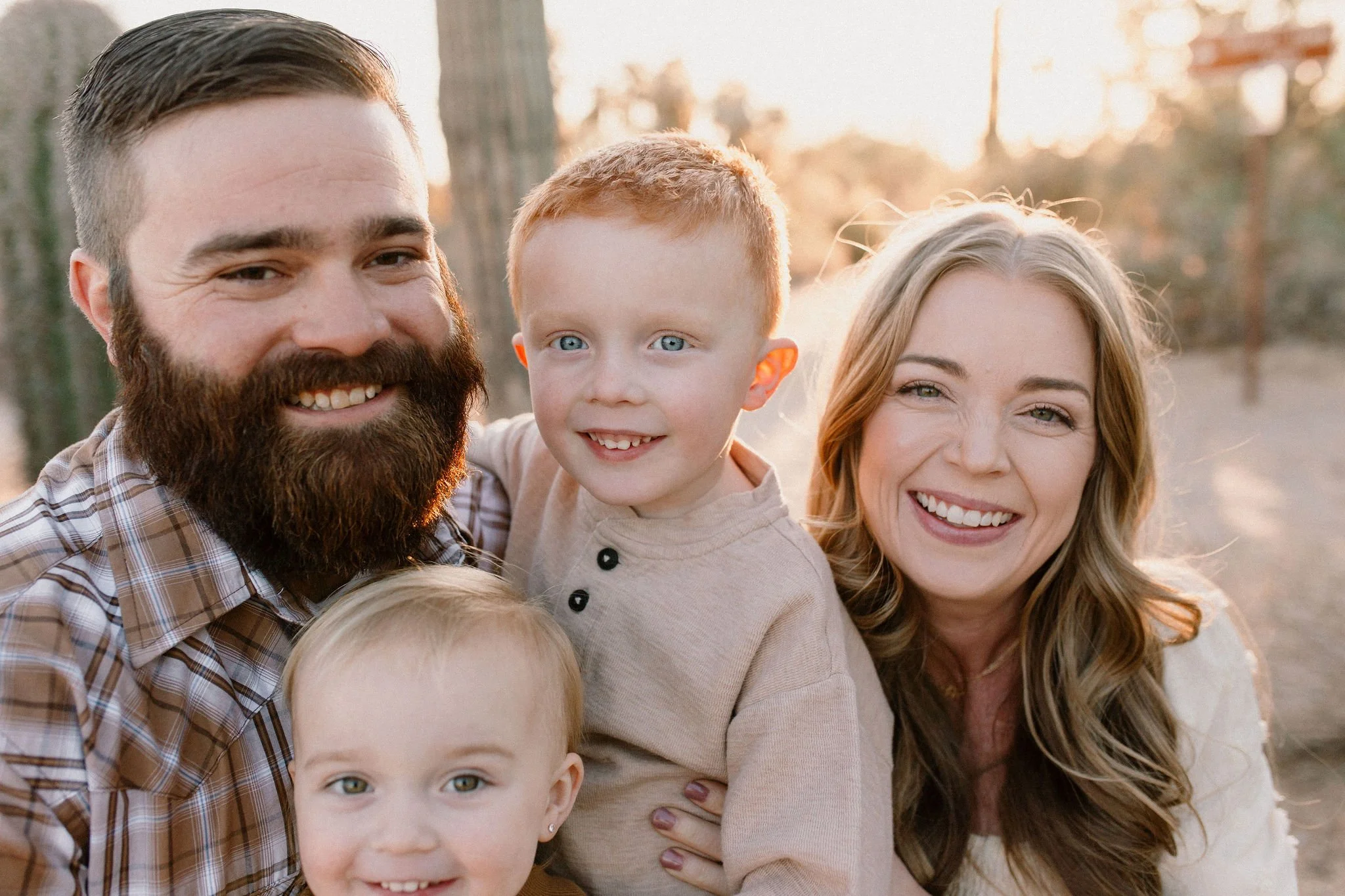 close up of toddler smiling and laughing with family during desert photography session