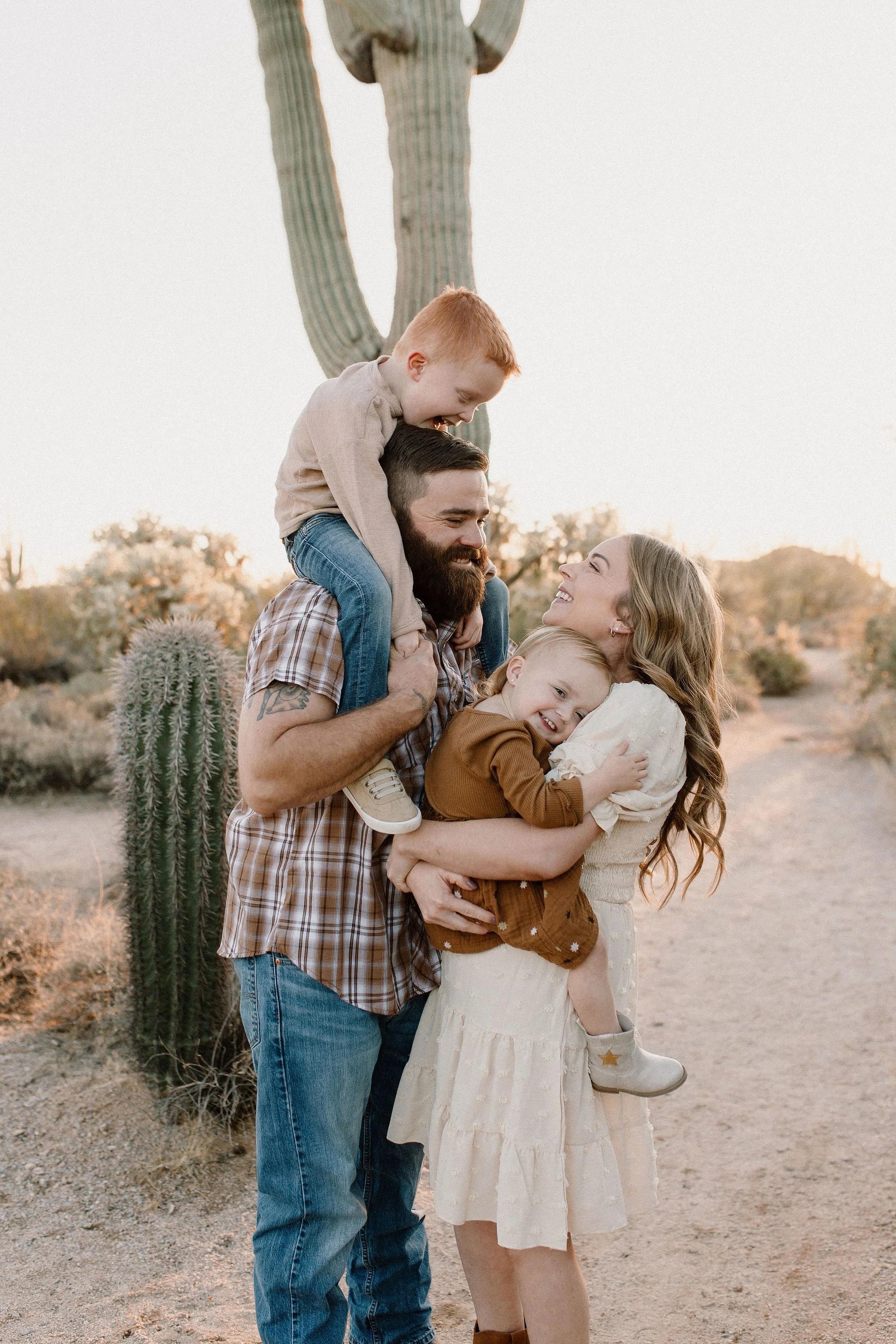 family standing close together interacting in golden hour desert family photography session