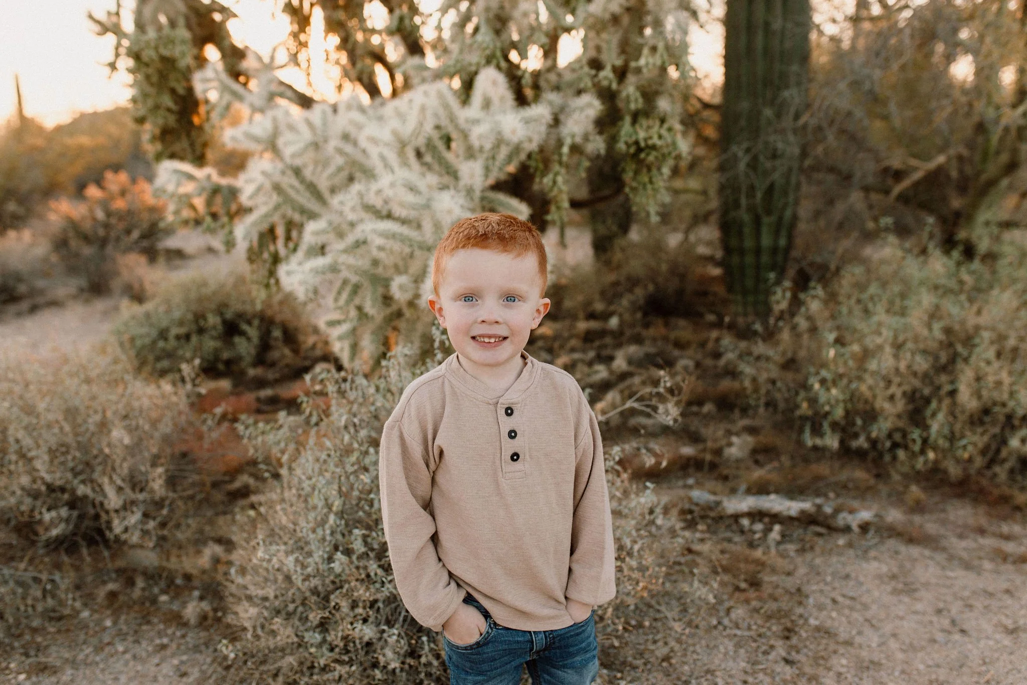 toddler standing and smiling in desert family photography session