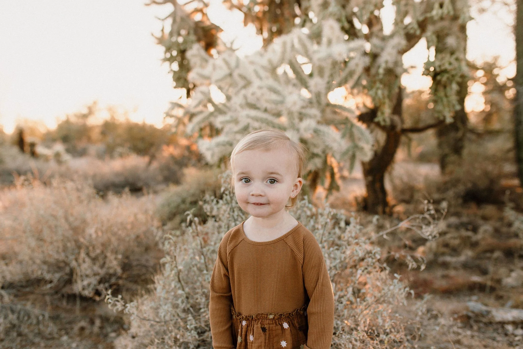toddler standing and smiling in desert family photography session