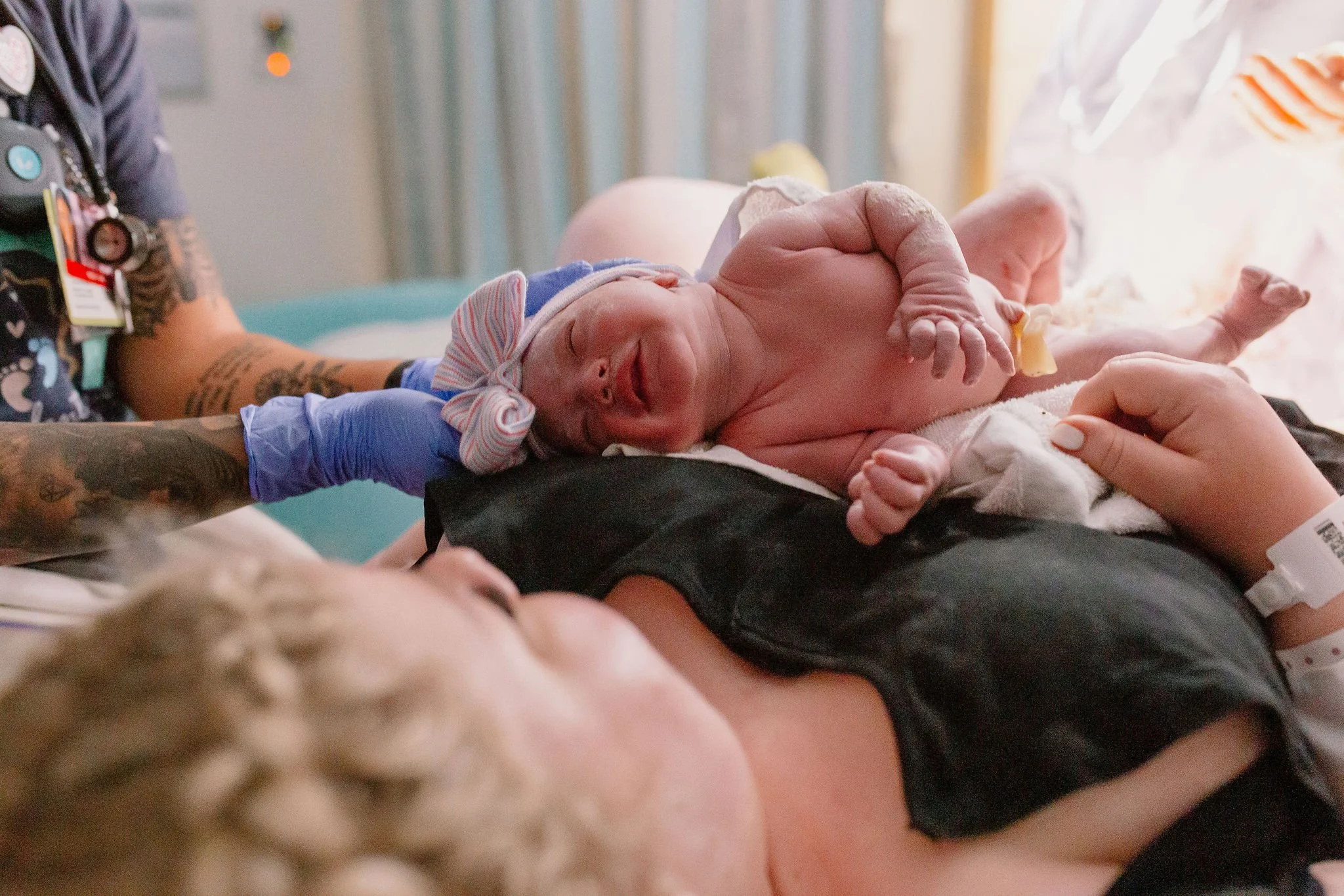 newborn baby placed on mom's chest immediately after birth by Mesa birth photographer