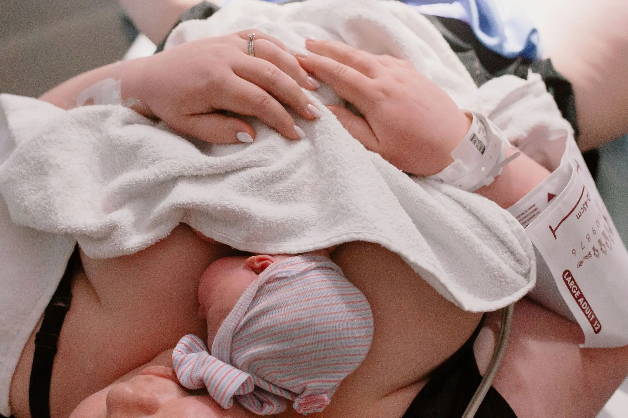 mom holding newborn baby after delivery in golden hour with Mesa birth photographer
