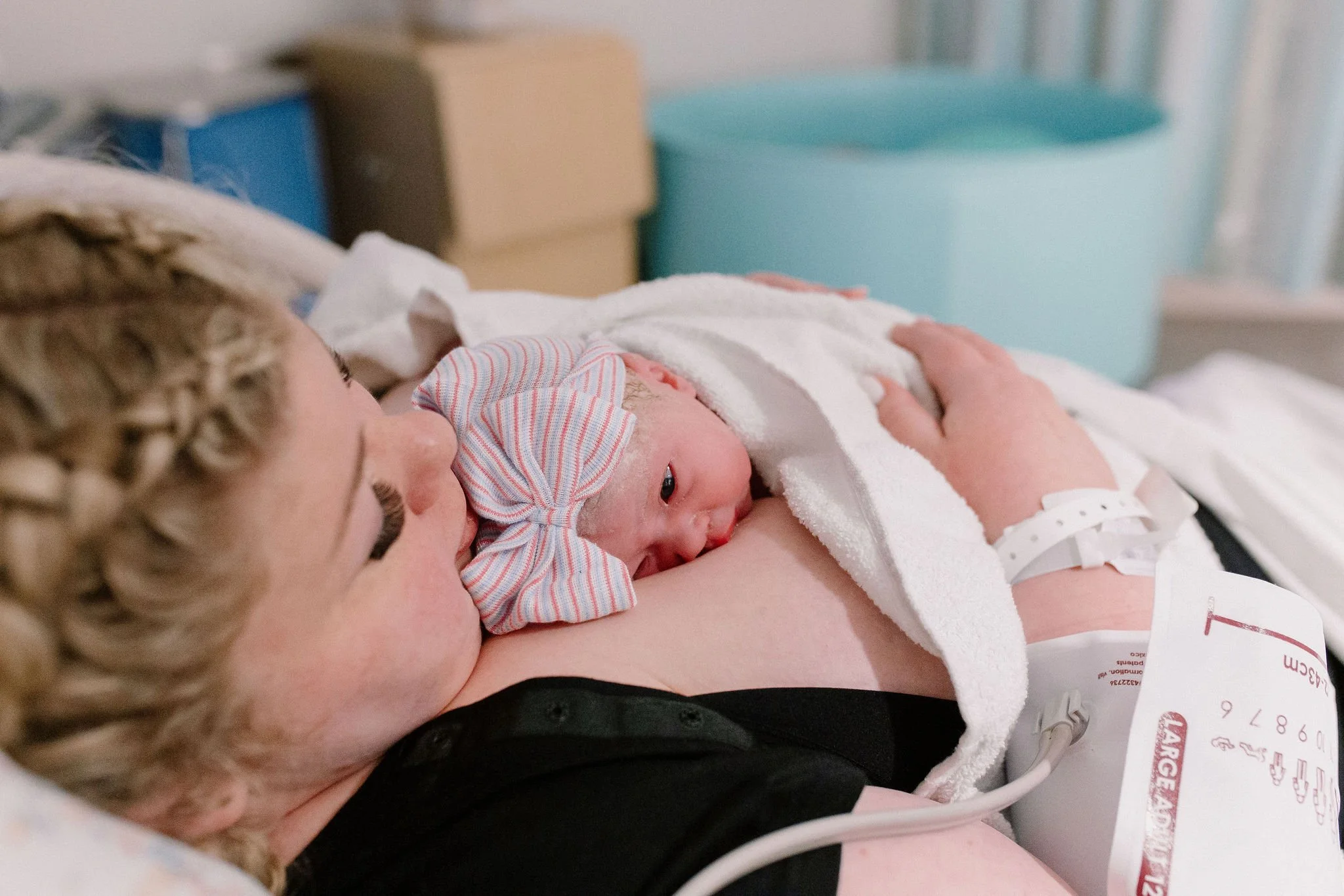 mom holding newborn baby immediately after delivery captured by Mesa birth photographer