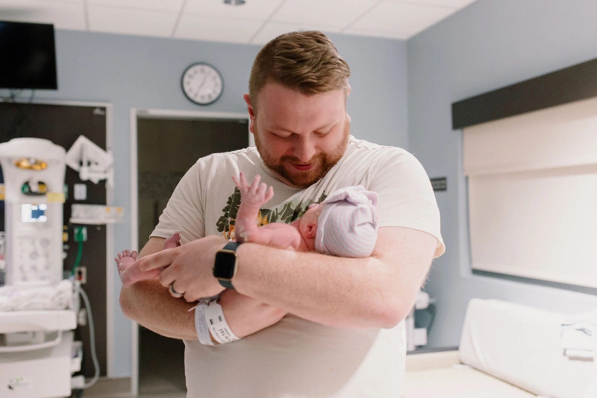 dad holding newborn baby captured by Mesa birth photographer