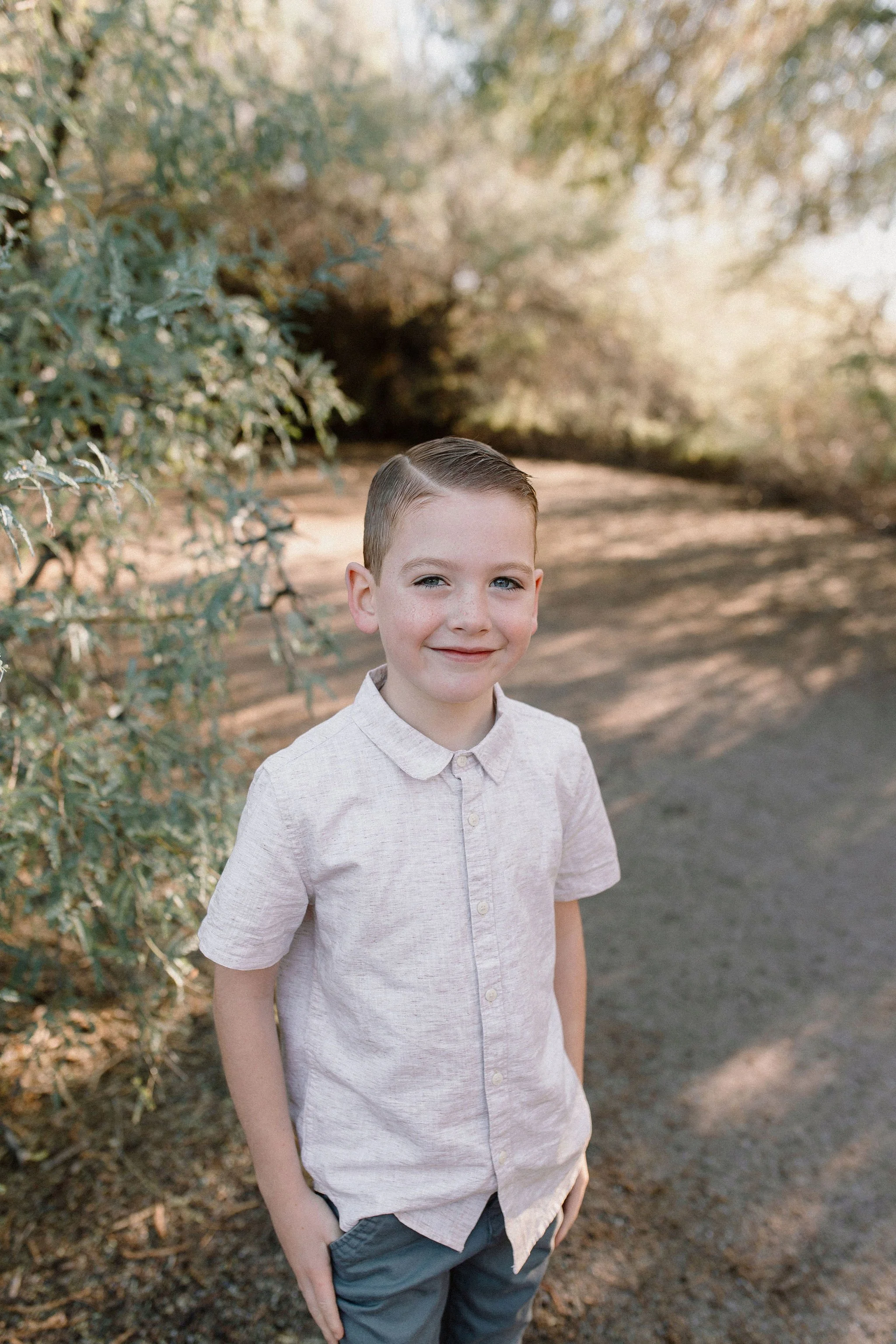 boy standing and smiling in desert greenery at Gilbert Riparian Preserve