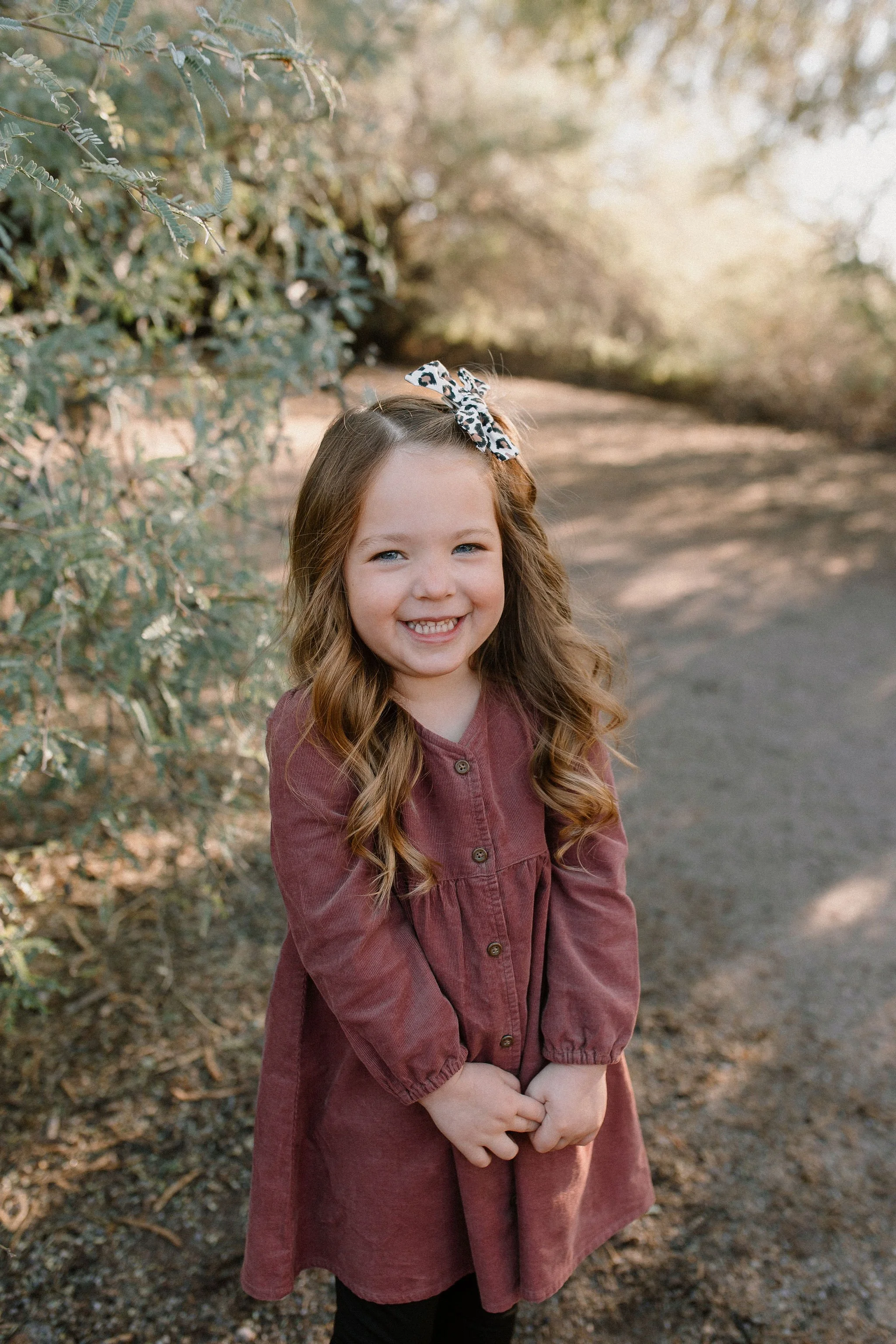 toddler standing and smiling in desert greenery at Gilbert Riparian Preserve