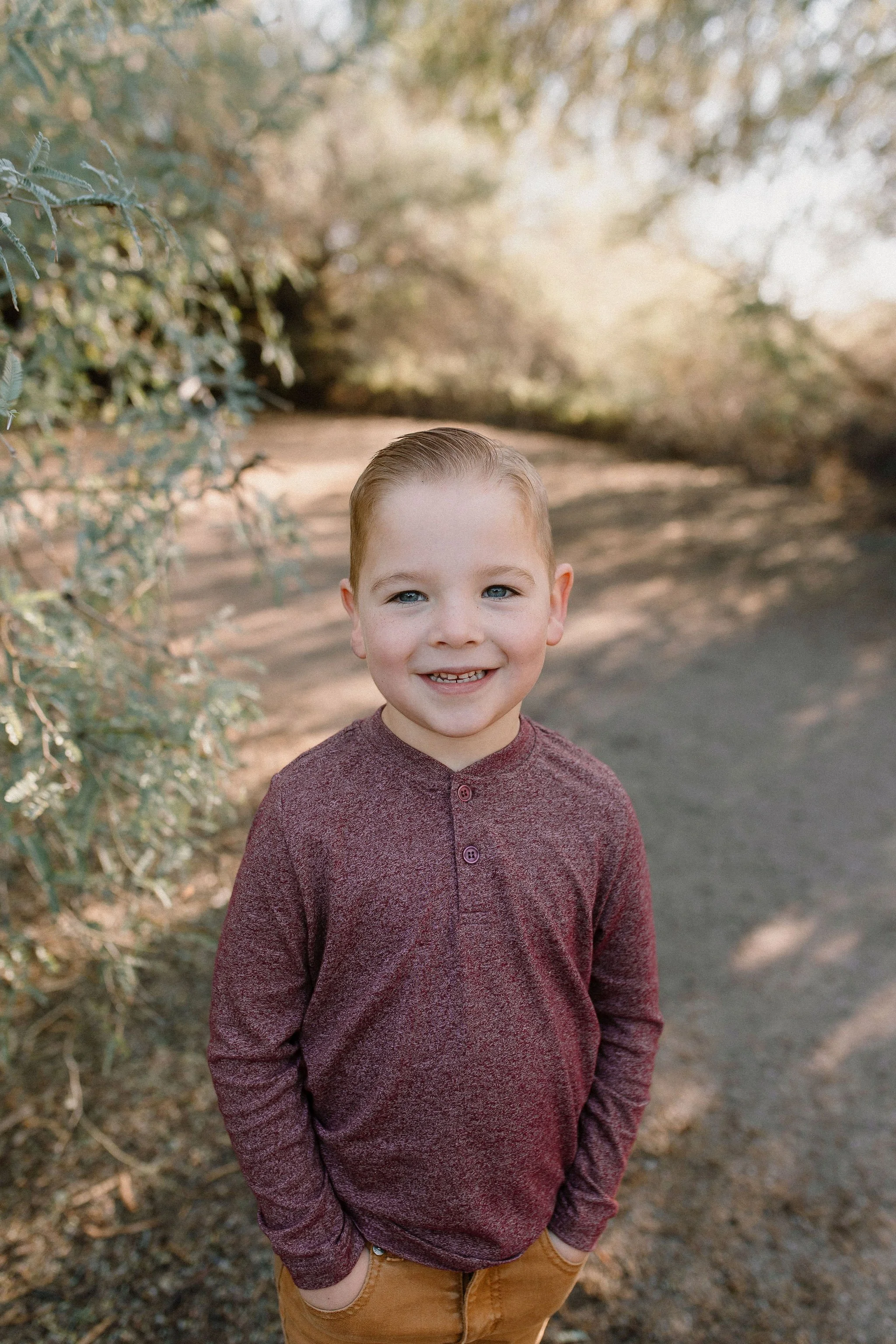 toddler standing and smiling in desert greenery at Gilbert Riparian Preserve