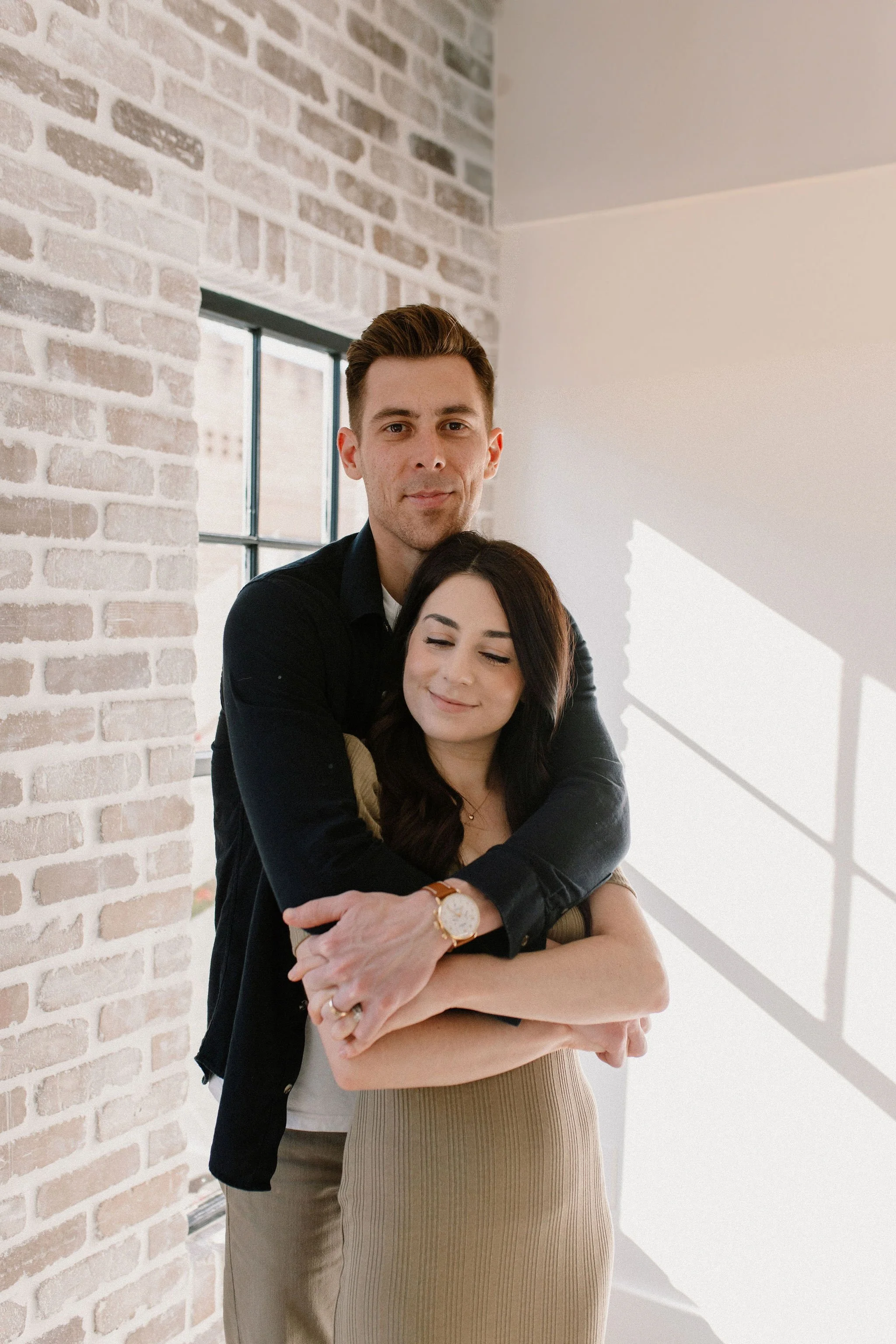 mom and dad hugging during family photo session in neutral studio in Phoenix, Arizona