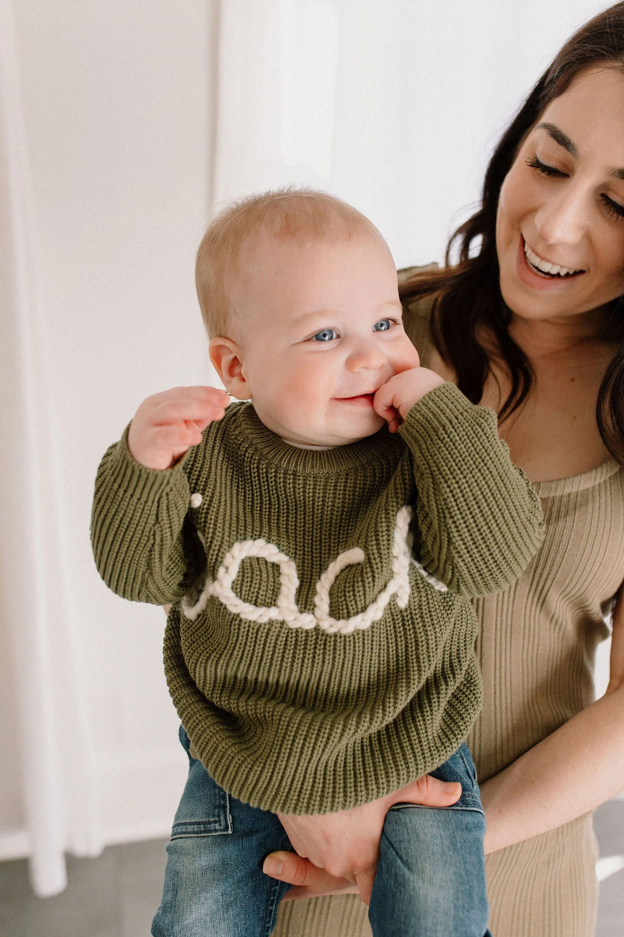 baby boy smiling during family session at neutral studio in Phoenix, Arizona