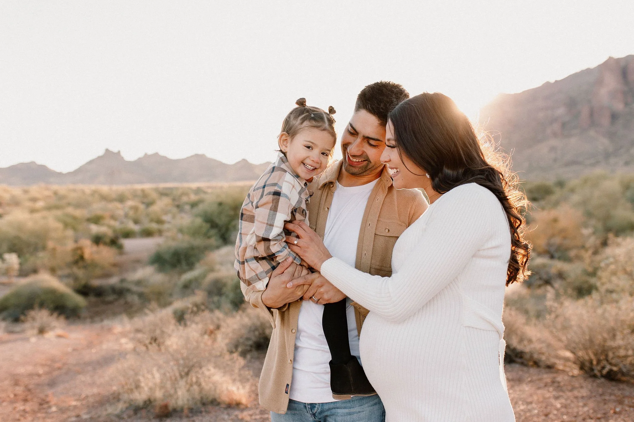 family laughing and smiling in desert family maternity pics in Lost Dutchman State Park