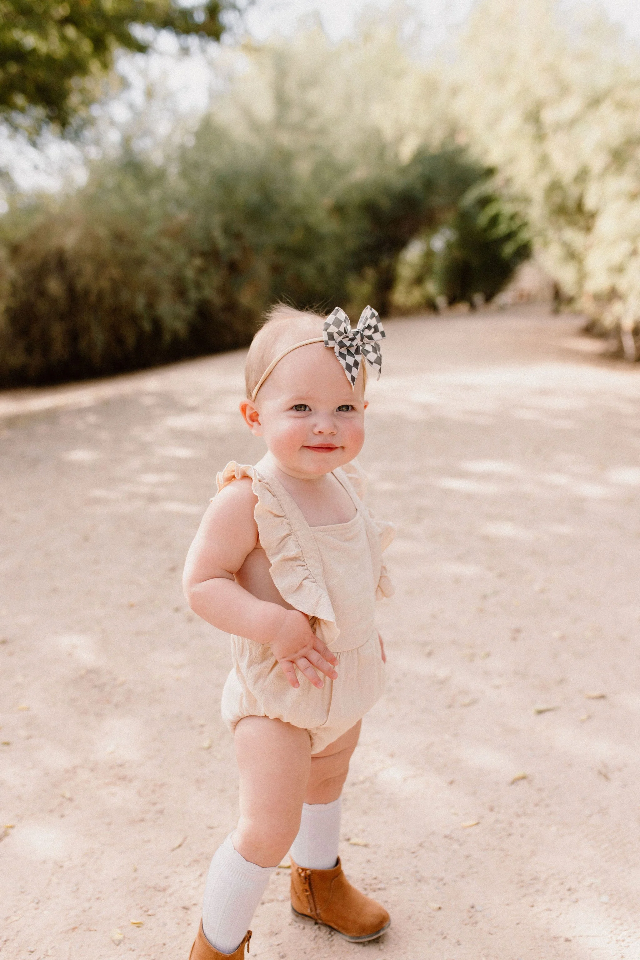 toddler standing and smiling during desert greenery family session