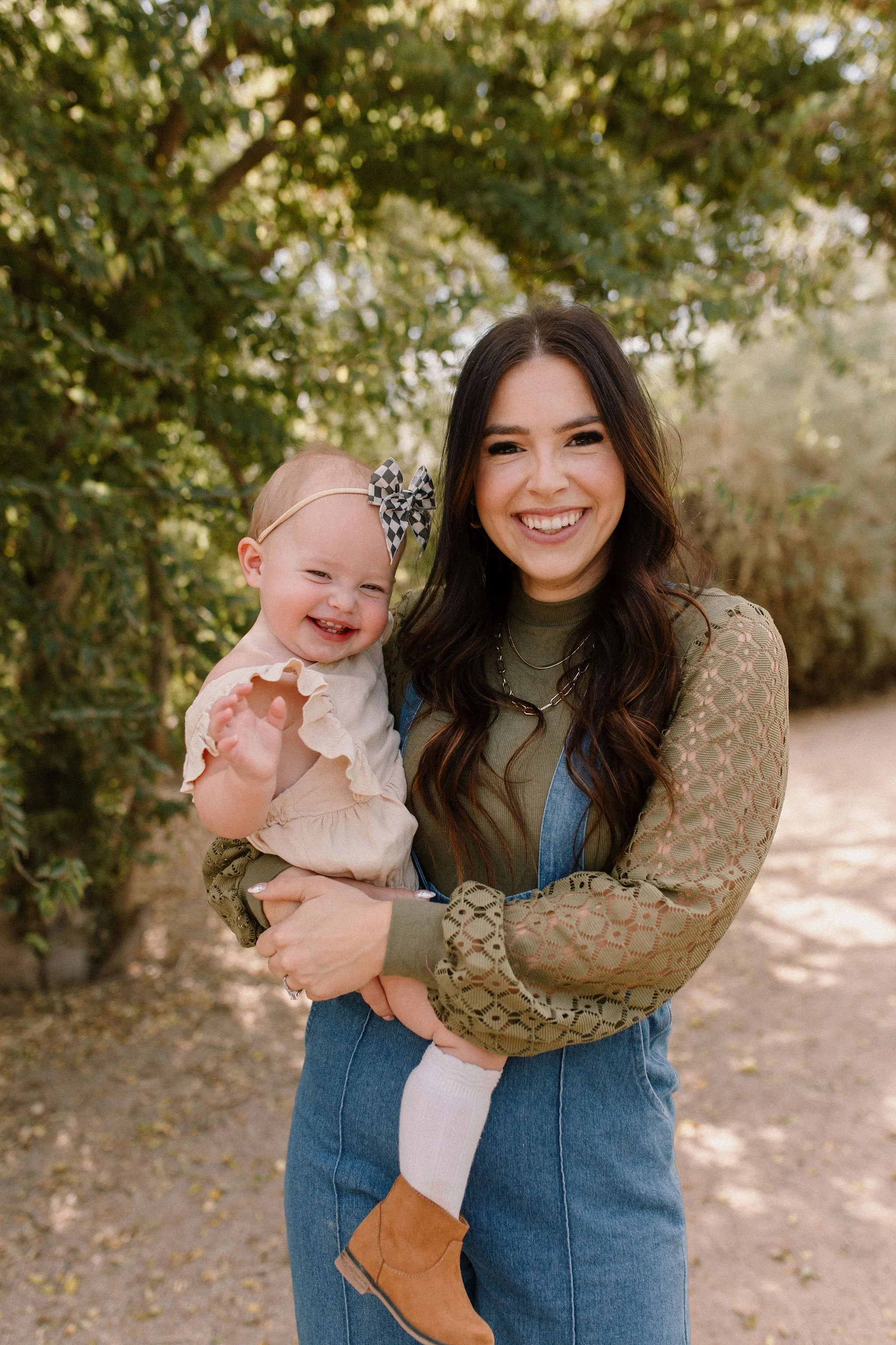 mom holding baby girl in desert greenery family photography session
