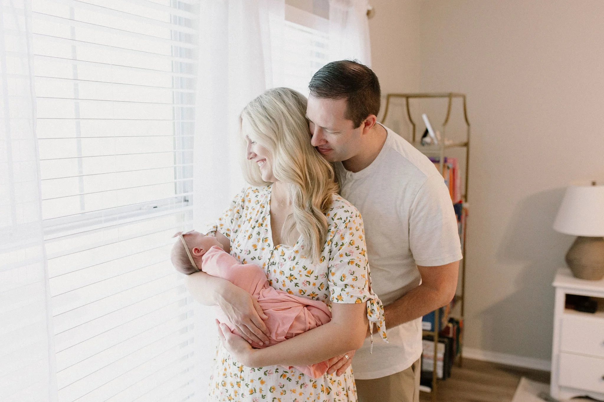 mom holding sleeping newborn with dad in Gilbert AZ photography session