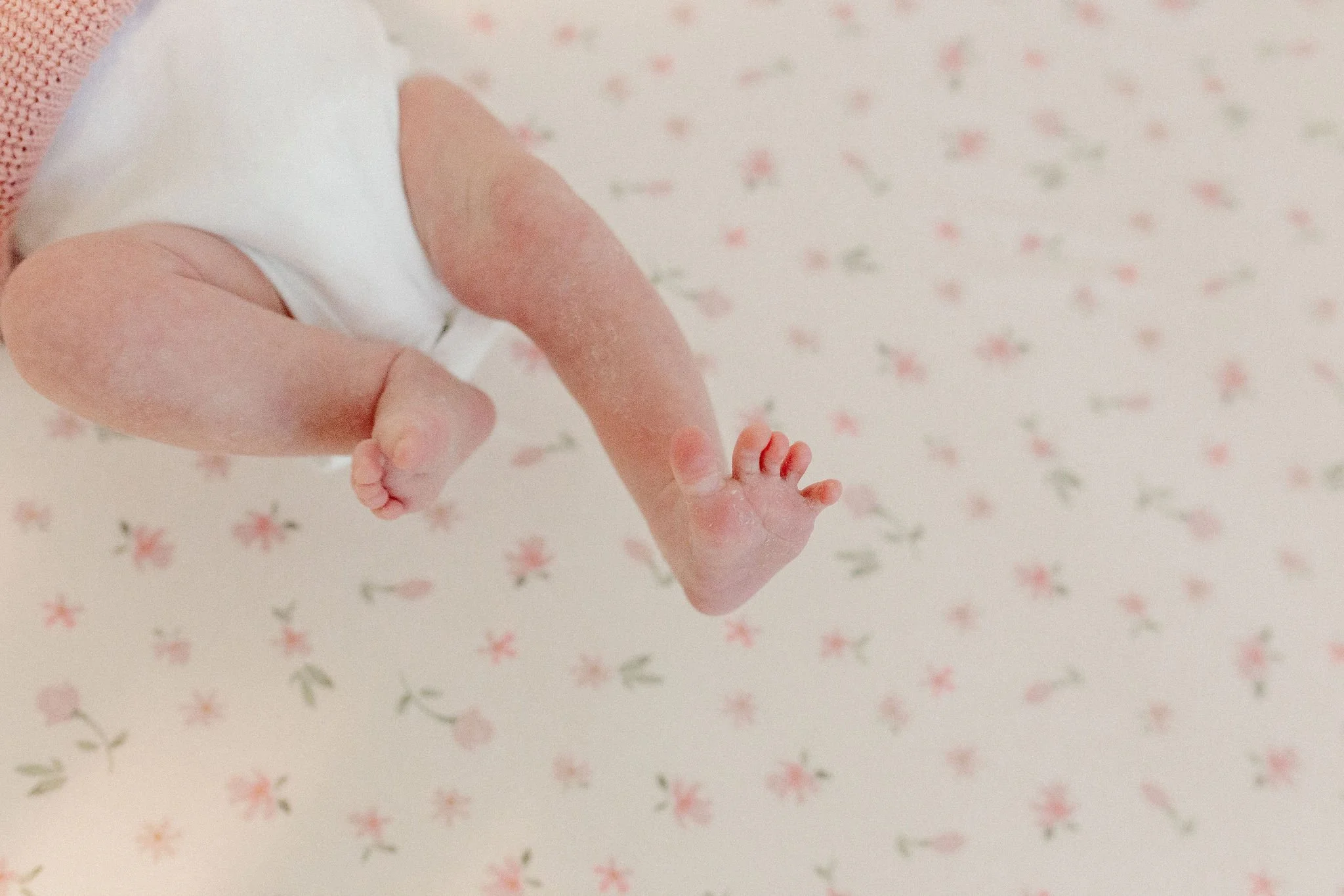 close-up detail shot of newborn baby feet and toes during lifestyle newborn photography session