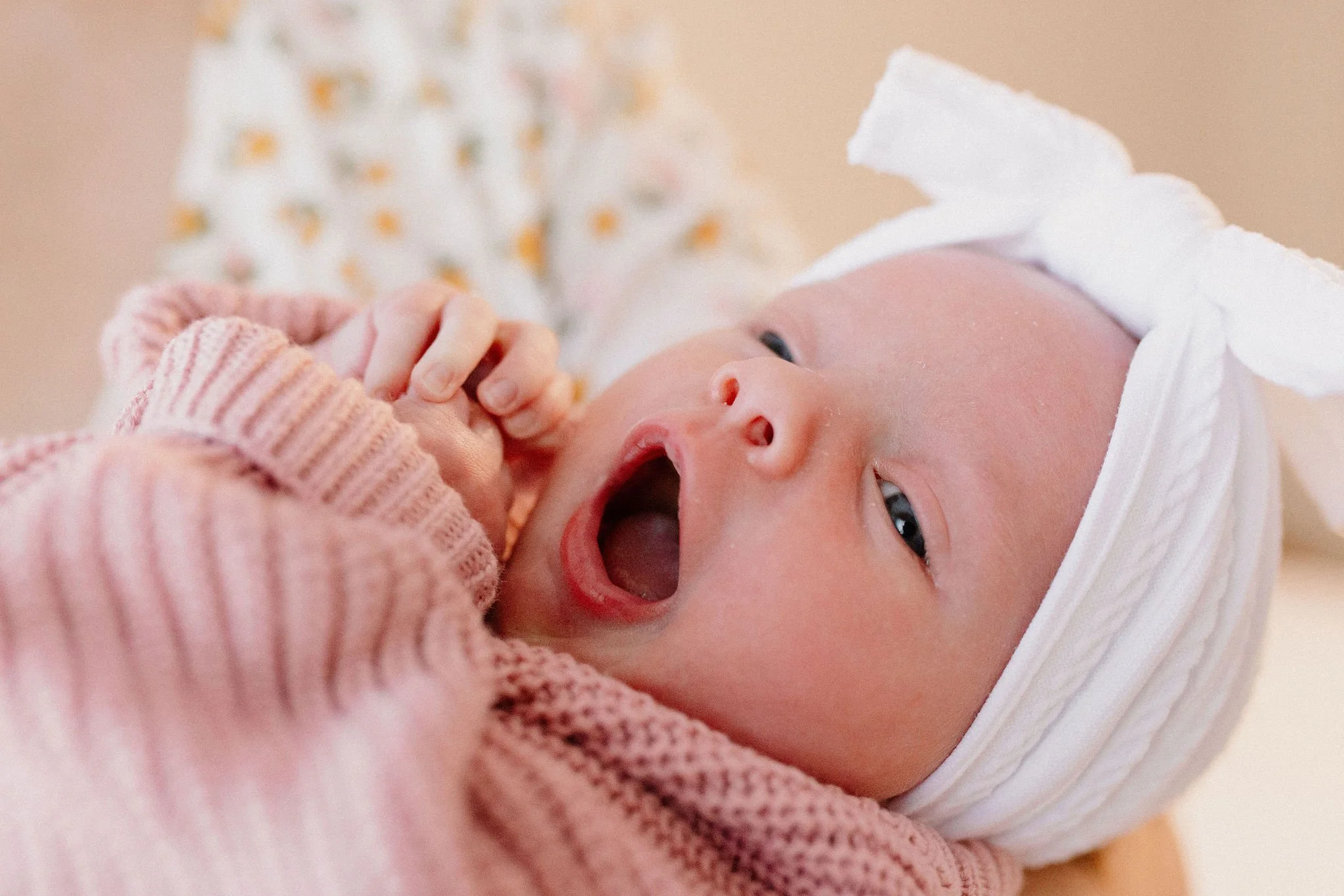 newborn baby girl yawning during lifestyle in-home photography session