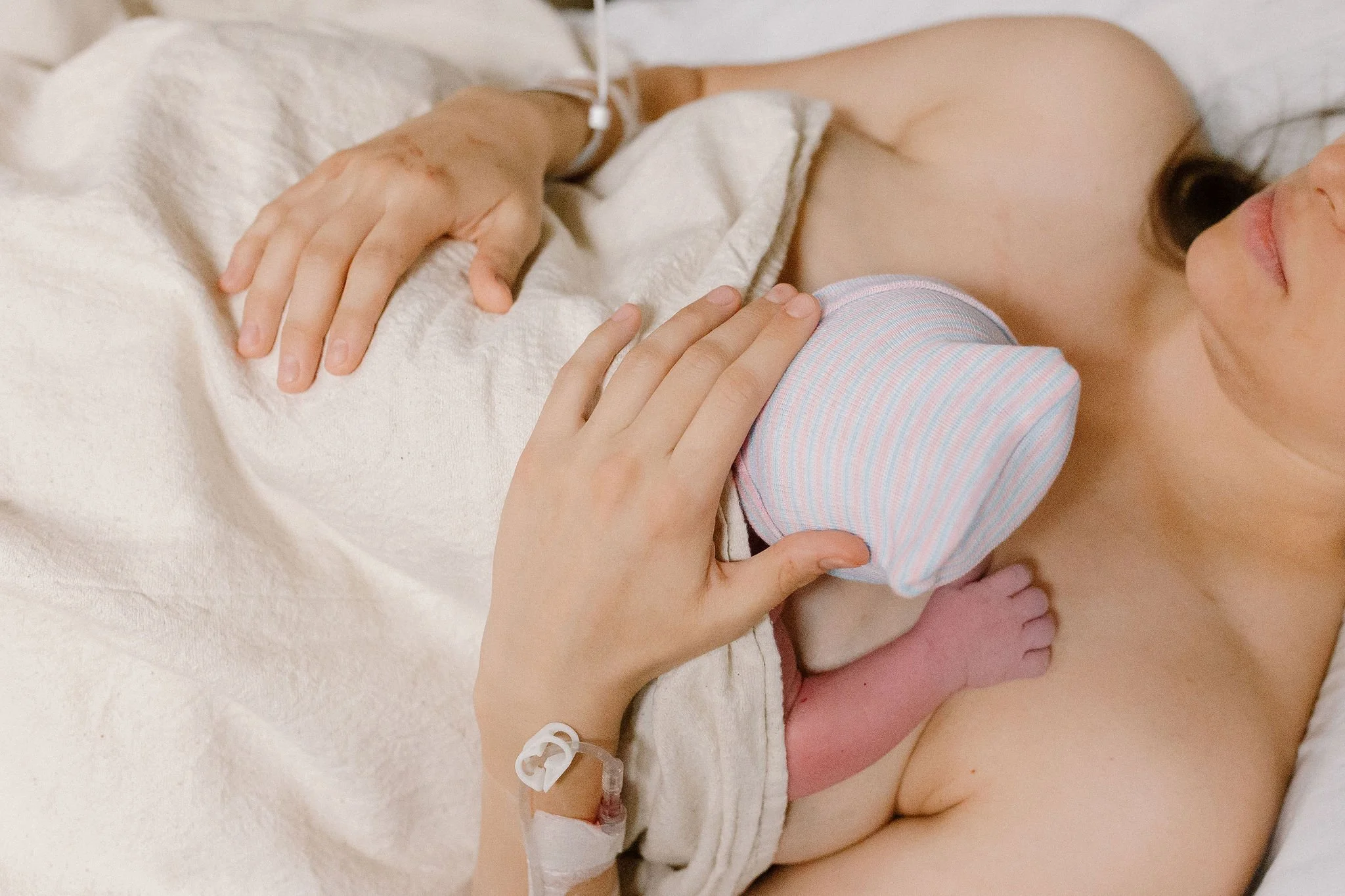 mom holding newborn baby in hospital birth photography in Gilbert, AZ