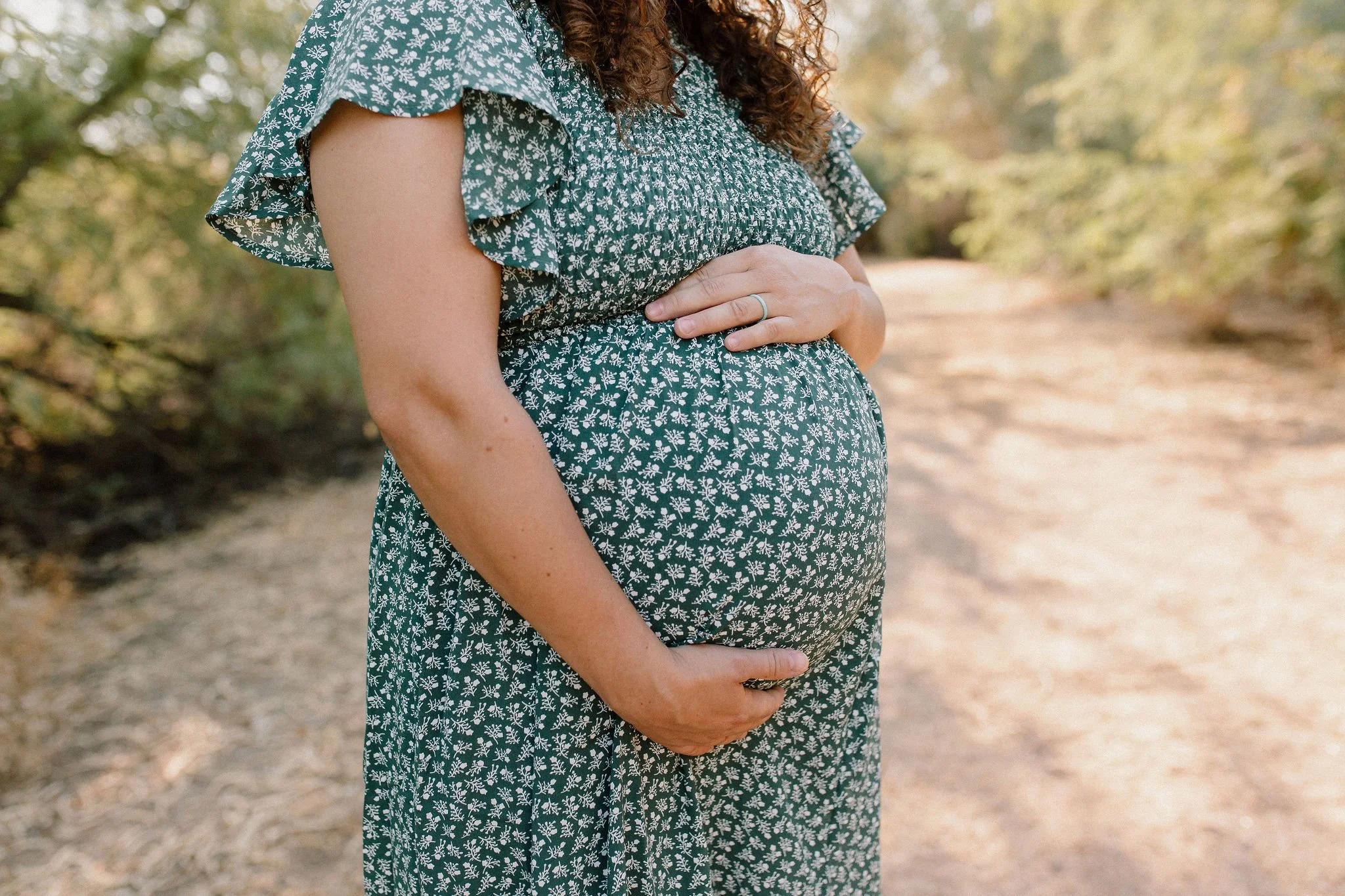 close up of pregnant belly during family maternity photography session