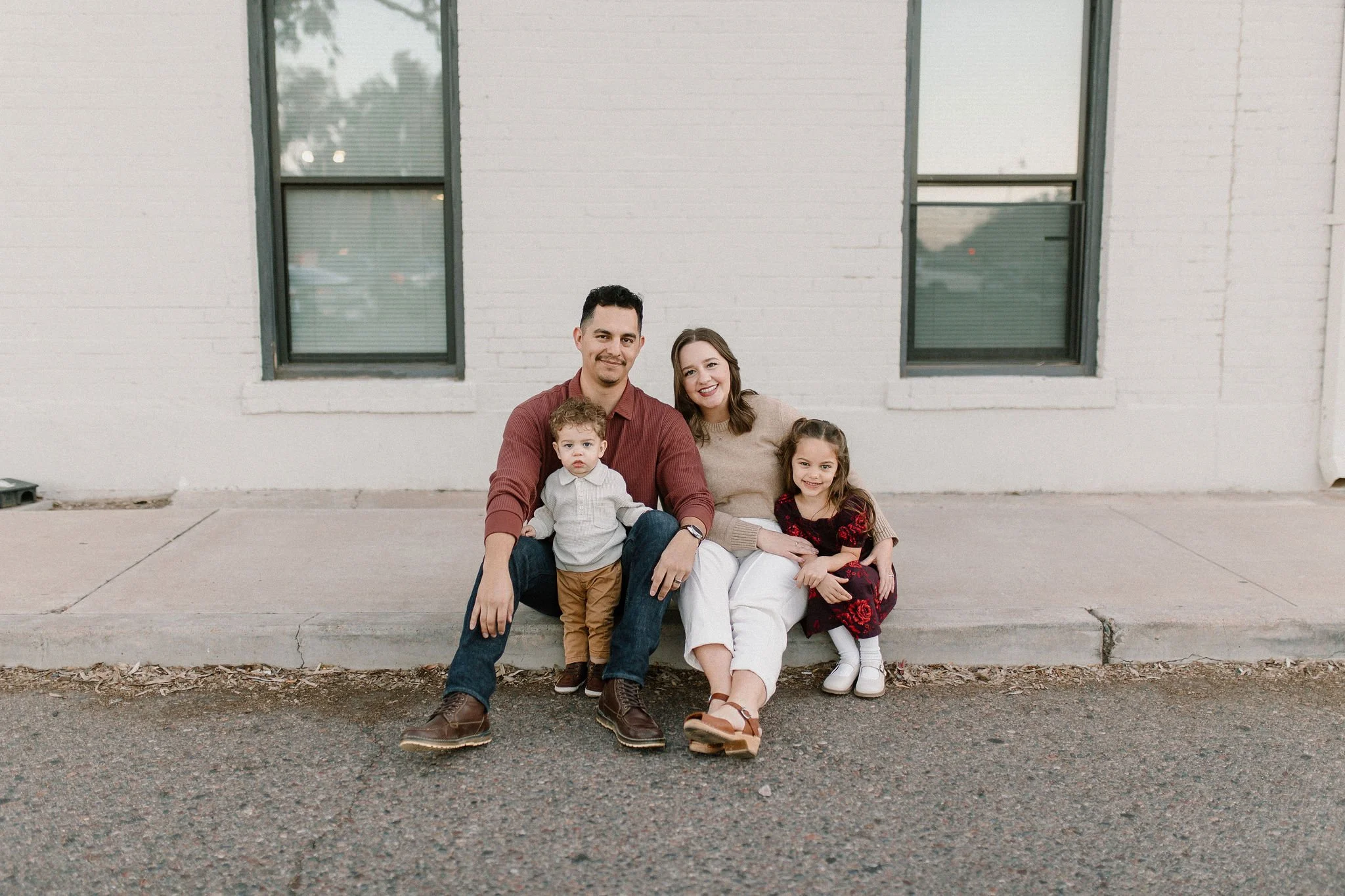 family sitting together and smiling in downtown mesa family photography session