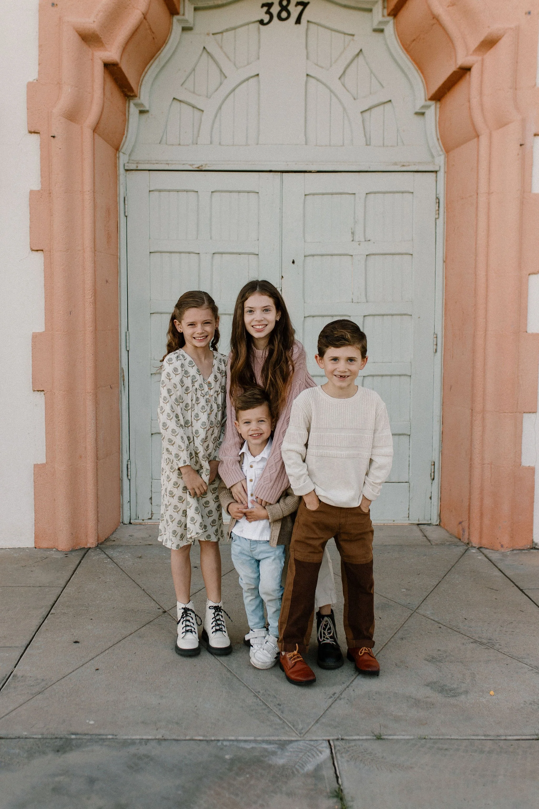 siblings standing together smiling during extended family photography session
