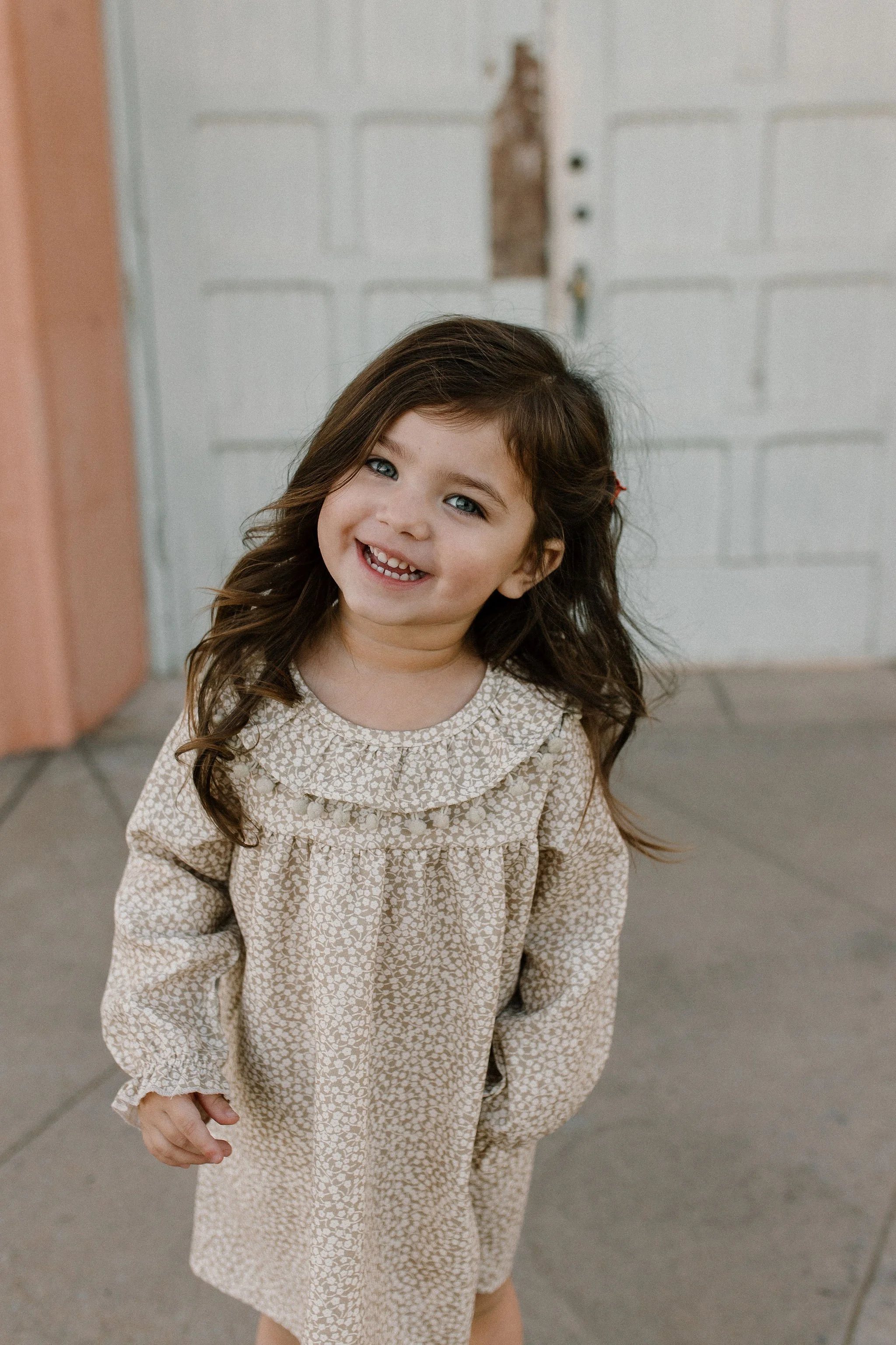 toddler girl smiling during extended family photos