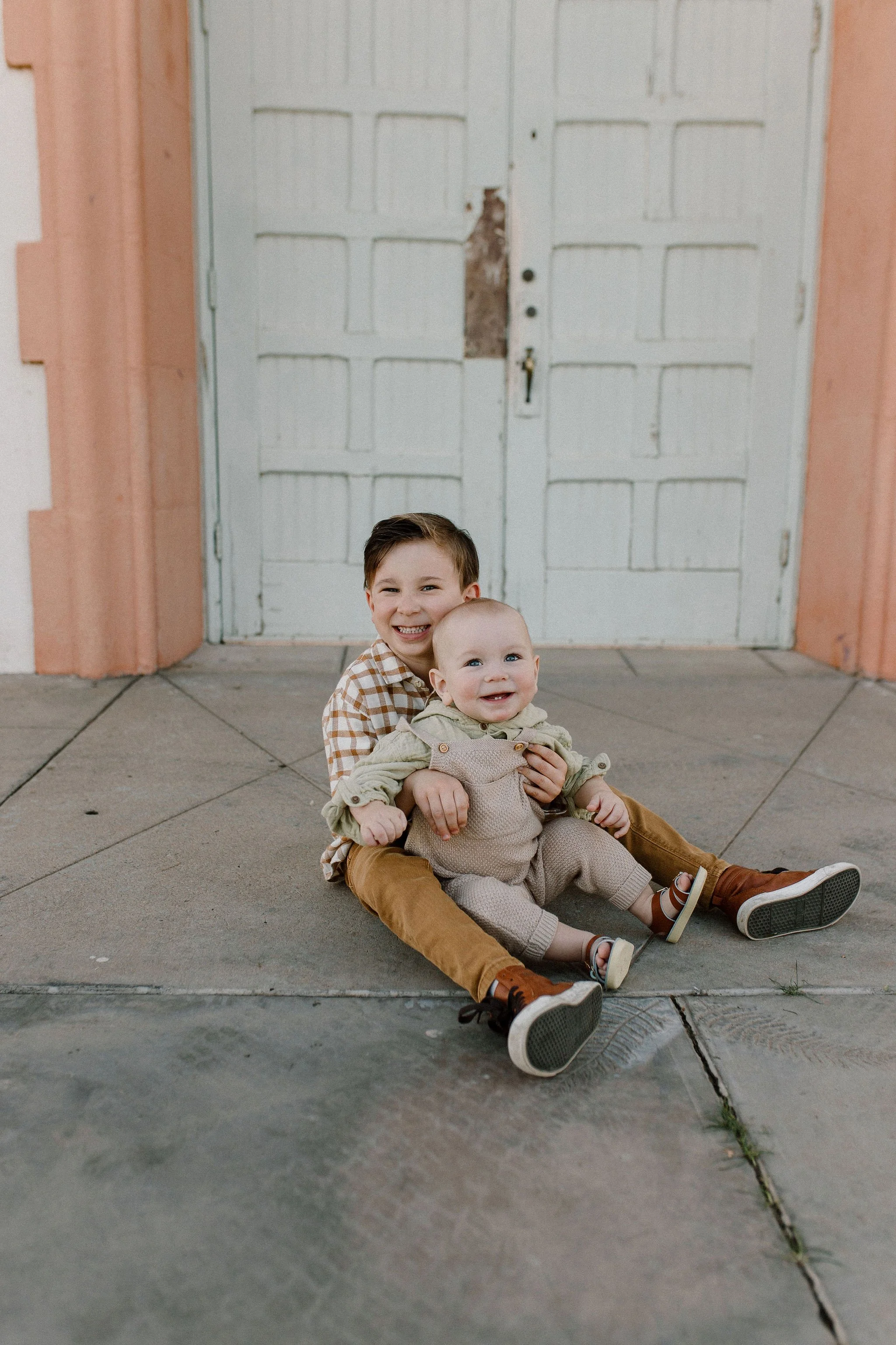brothers sitting together smiling during extended family photography