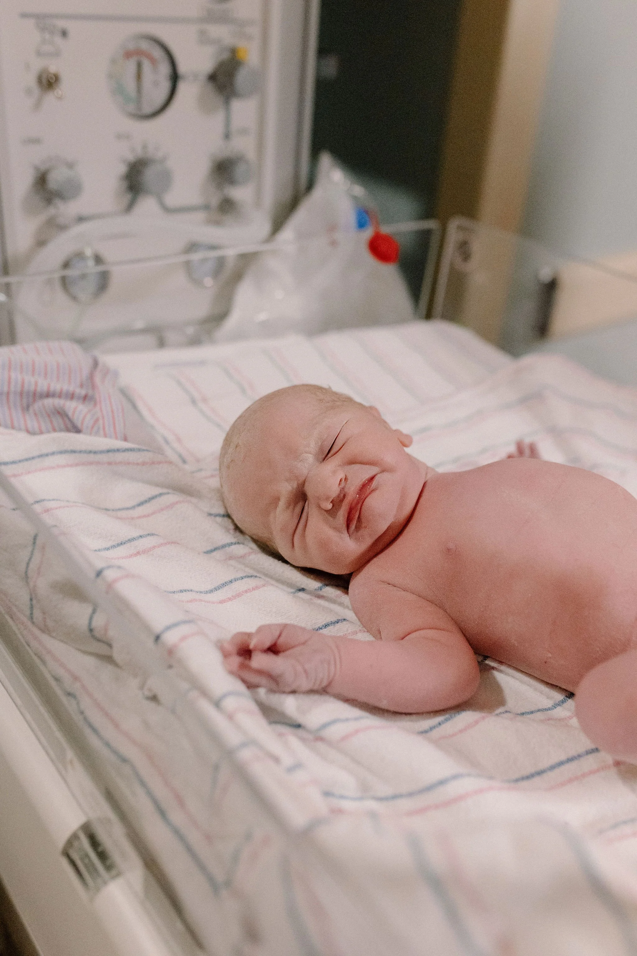 newborn baby laying in warmer immediately after hospital birth