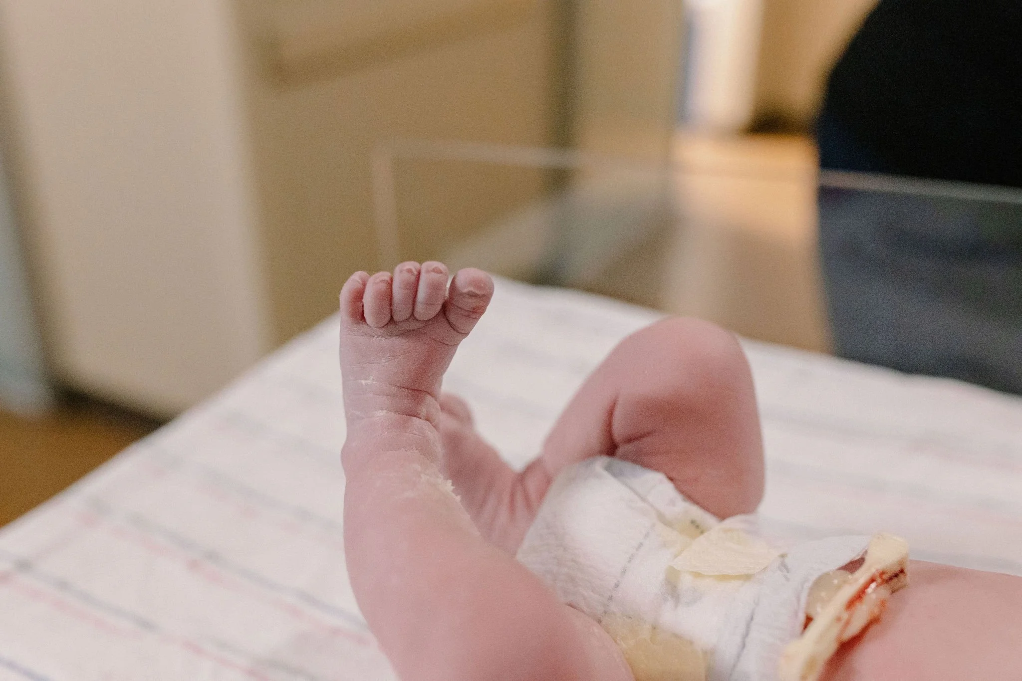 close-up of newborn baby feet and toes immediately after hospital birth