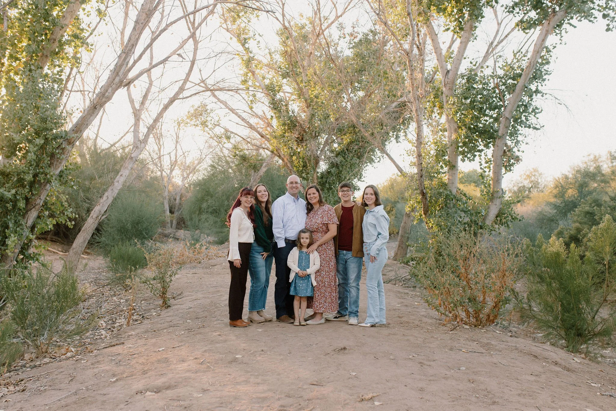 Family standing in the trees in Queen Creek photography session