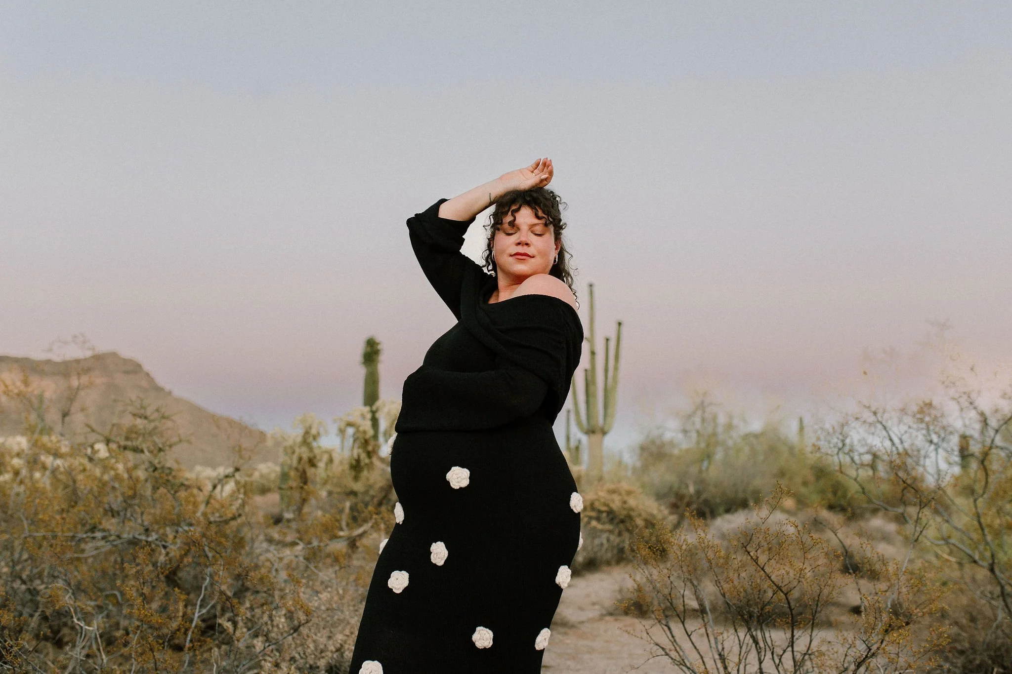 pregnant mom holding belly during blue hour maternity photoshoot in Gilbert, Arizona